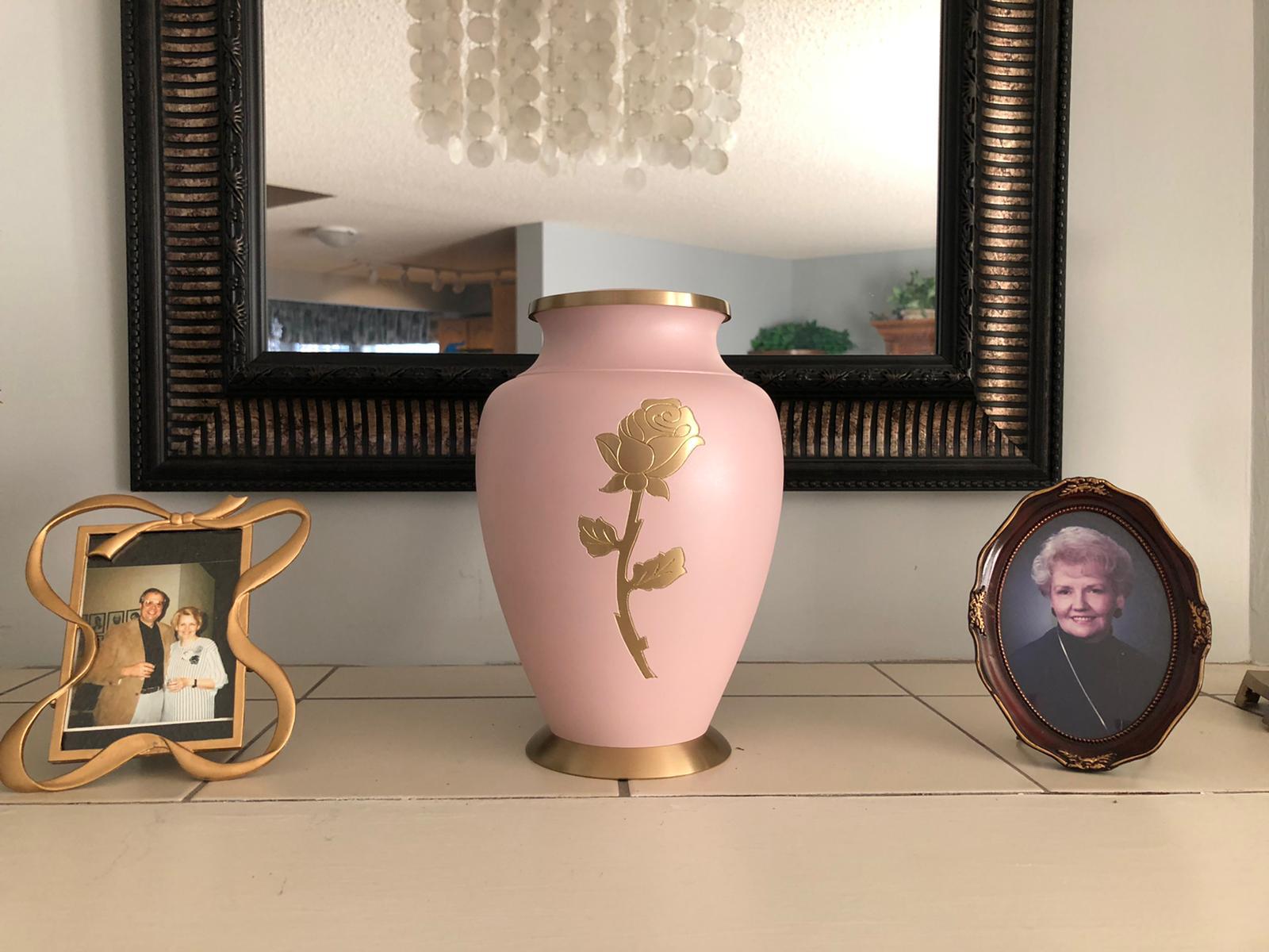 Marlene Ducommun’s ashes rest in an urn next to a photo of her and her late husband. (Submitted by the Ducommun family)