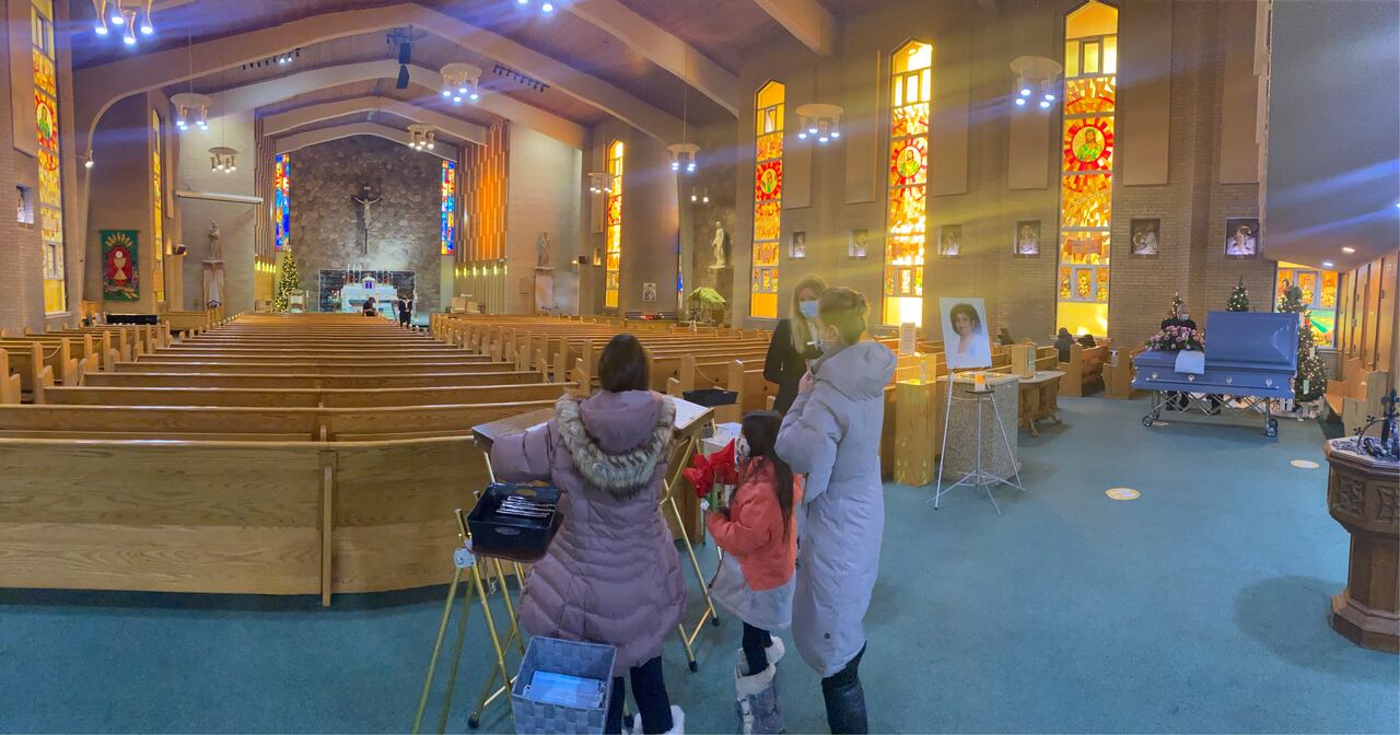 Photo of a funeral in a nearly empty church in December 2020, when Alberta’s public-health restrictions limited attendance to a small number of mourners. (Submitted by Cajetan Viegas)