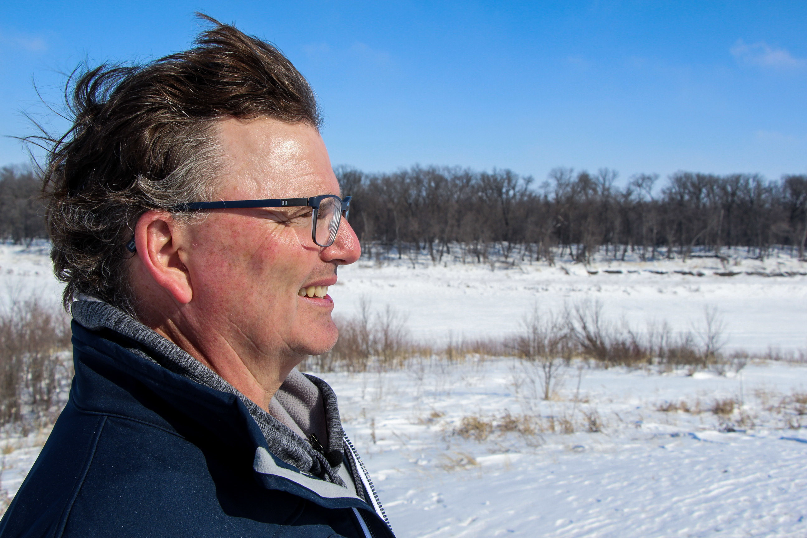 Rob MacLeod looks out from his property next to the Red River. (Ahmar Khan/CBC)