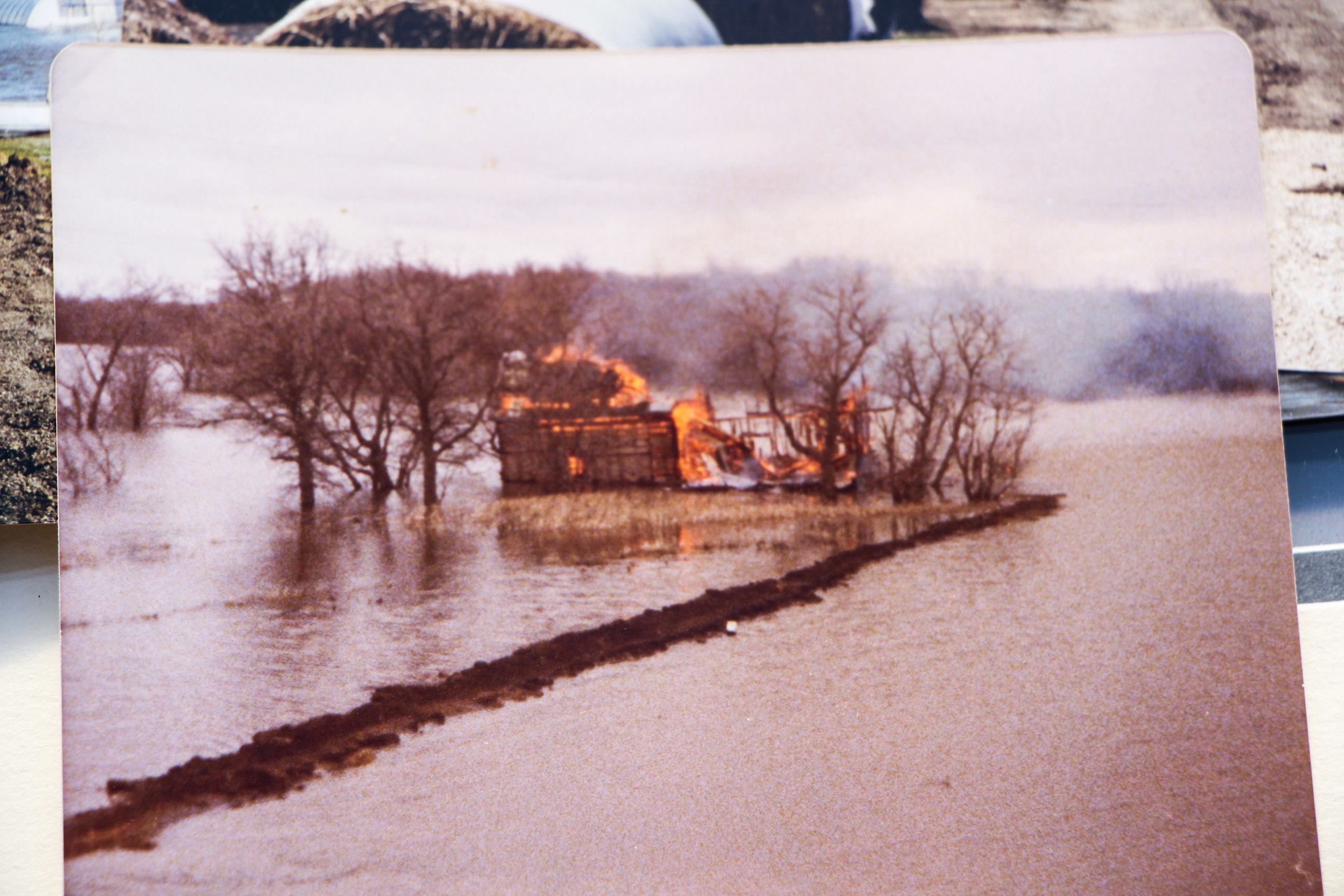 The MacLeods share a photo of a house burning during the flood of ‘09. (Ahmar Khan/CBC)