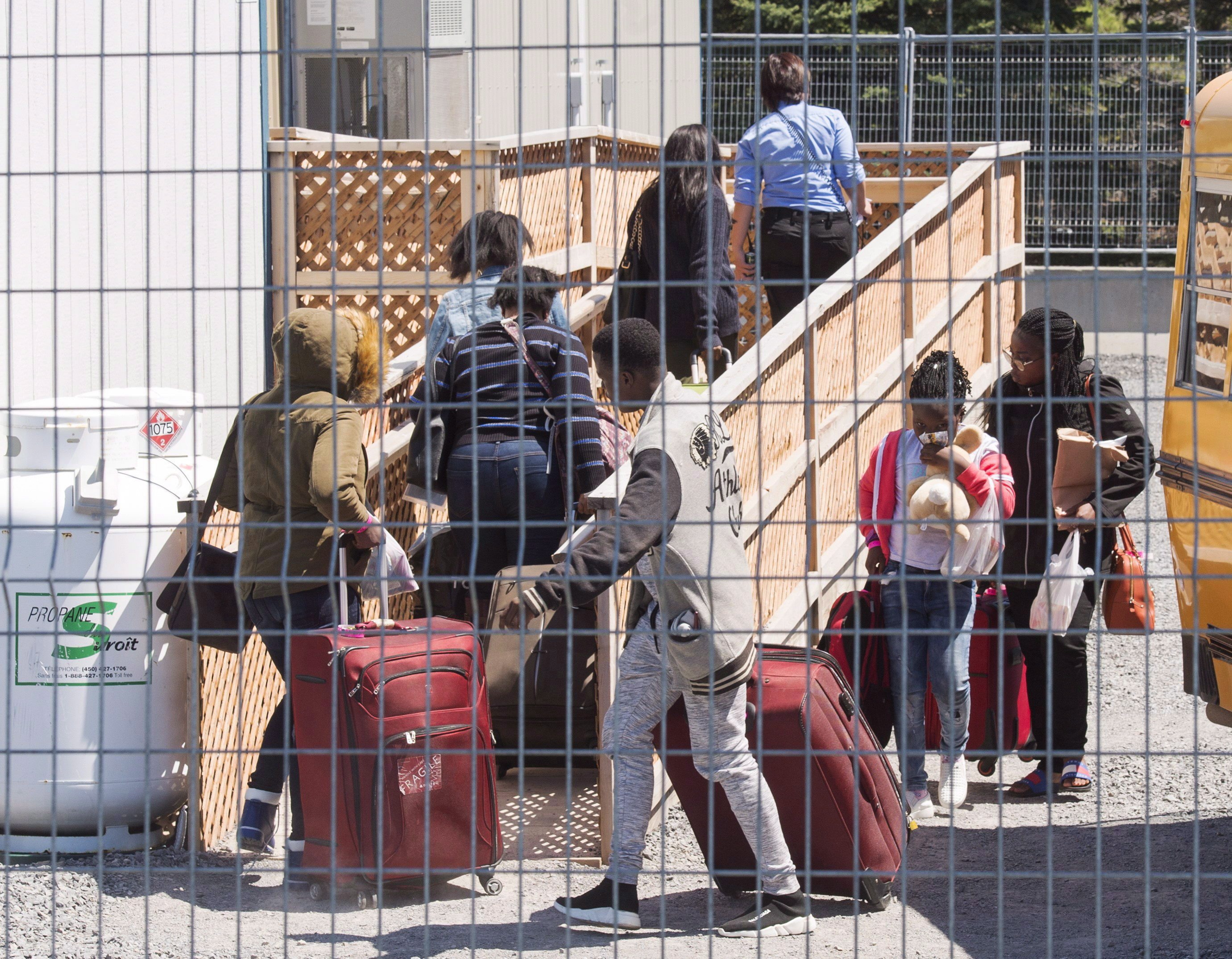 Thousands of migrants have crossed into Canada at Roxham Road, which straddles the Quebec-New York border, in recent months. (Ryan Remiorz/Canadian Press)