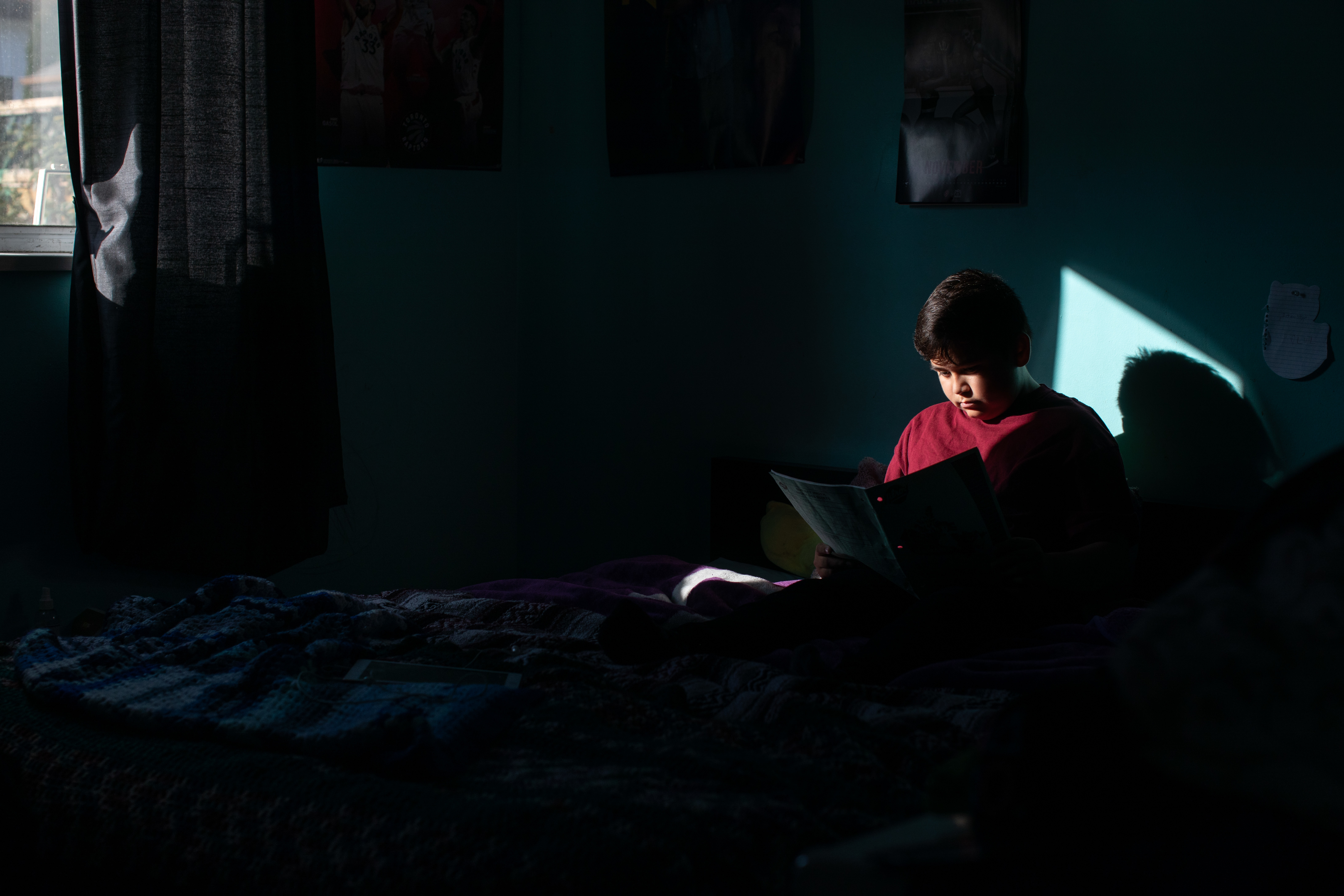 Creighton Angus-Morrison, 12, reads Sm’algyax, a dialect of the Tsimshian language, from his notebook in his home in Burnaby on Nov. 19, 2019. (Maggie MacPherson/CBC)