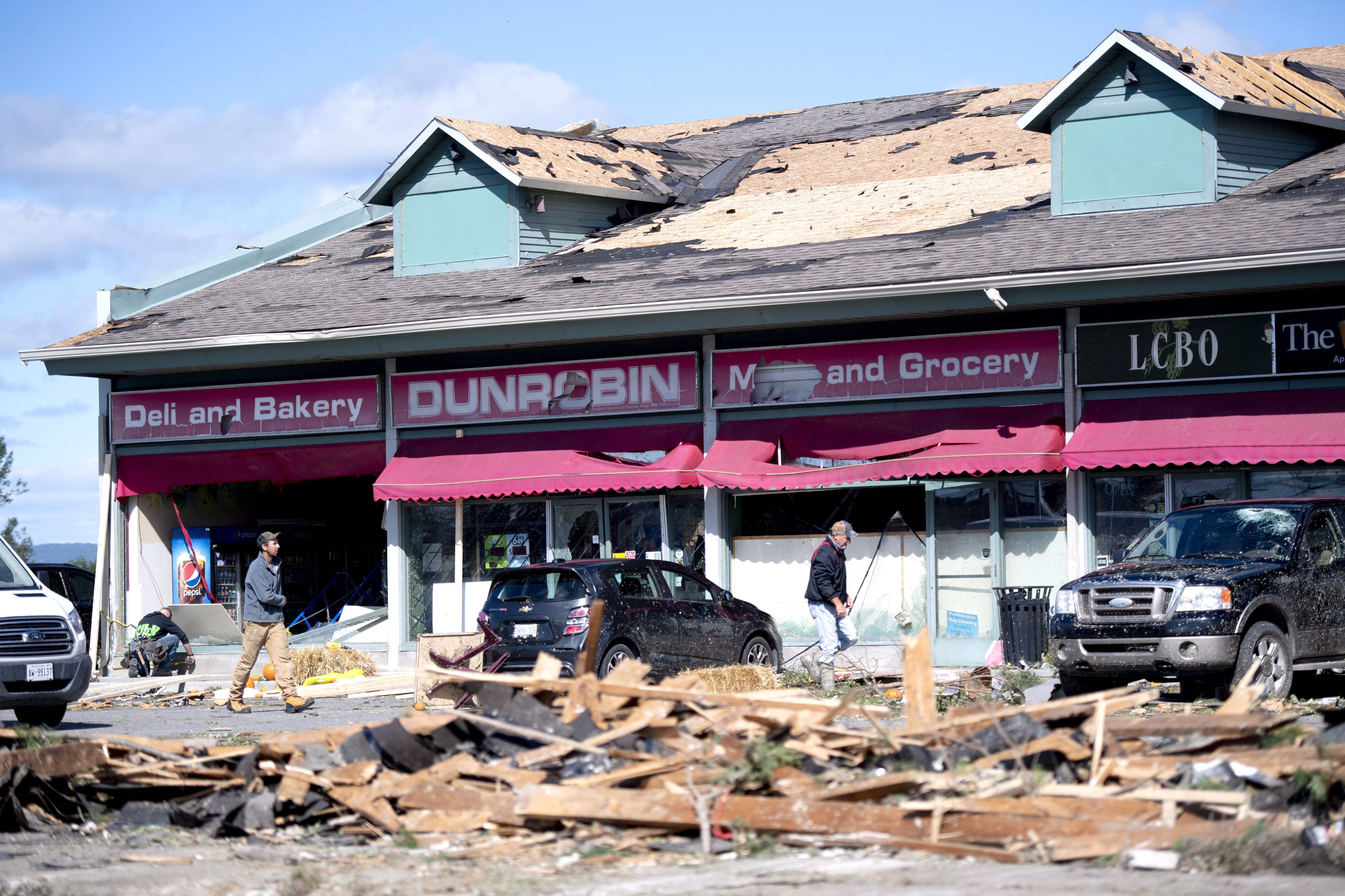 Dunrobin residents cleaned up on Sept. 22 following the tornado. (Justin Tang/Canadian Press)