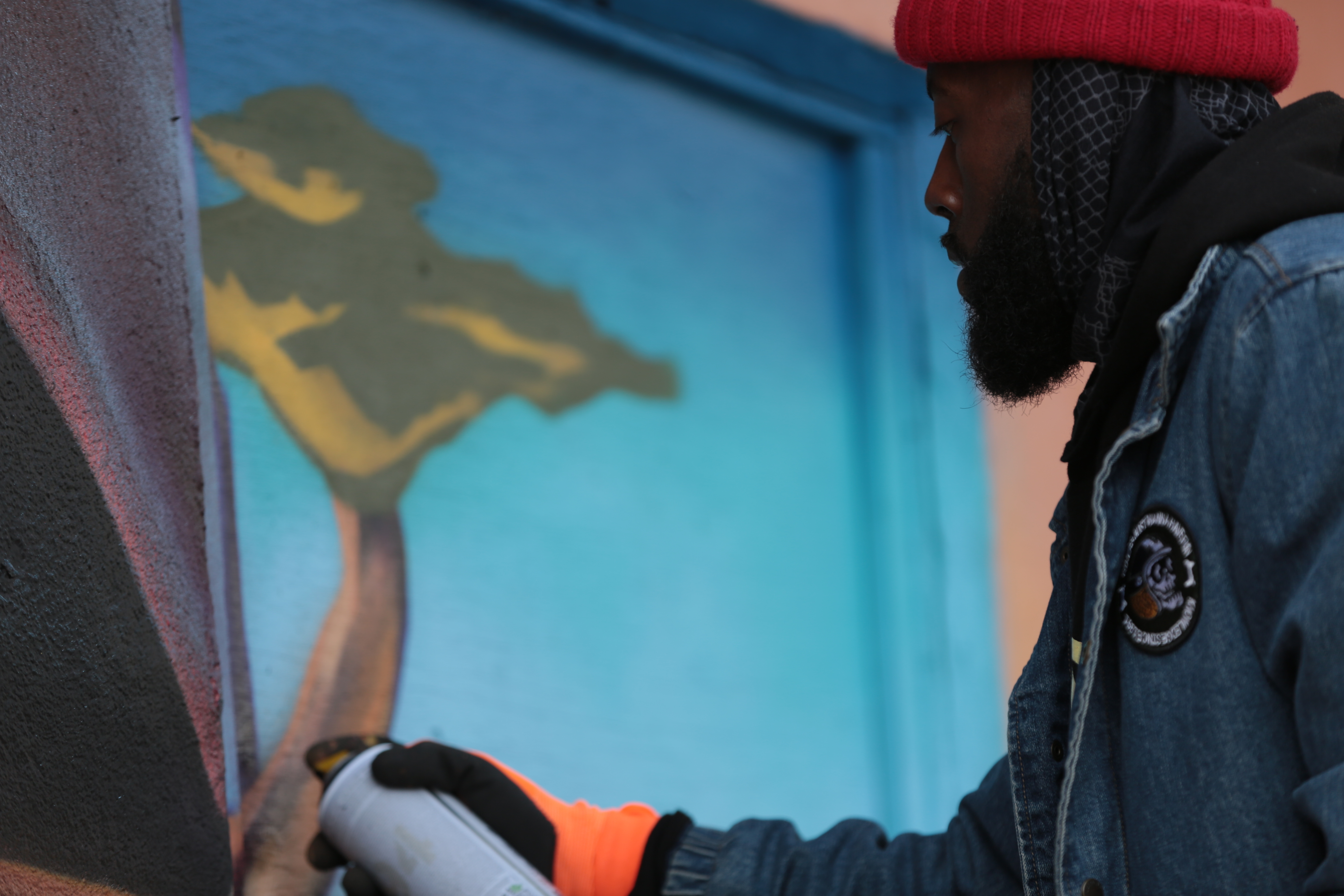 Kalkidan Assefa is hopeful his new mural on the side of the Origin Art and Community Centre will have staying power, because the space is respected as a cultural hub for the Black community in Mechanicsville. (Simon Gohier/CBC)
