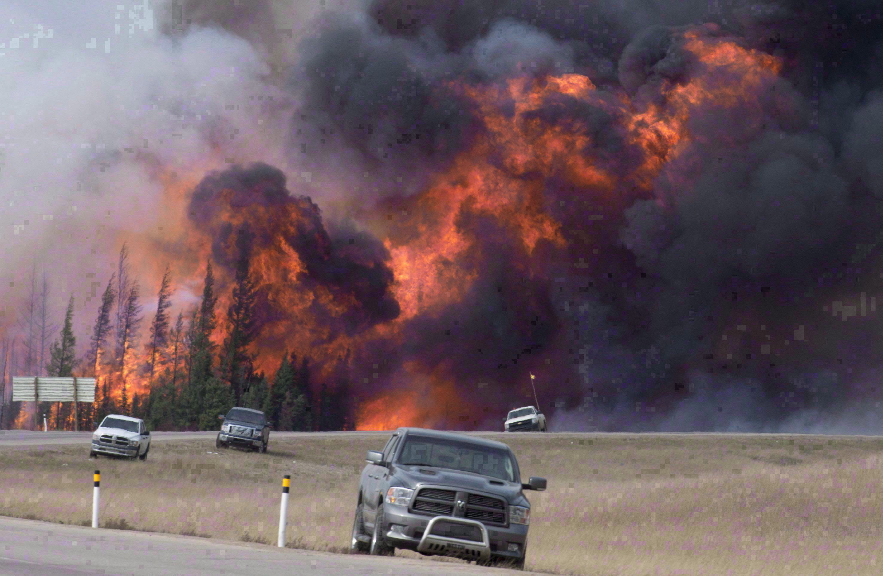 A wildfire ripped through the forest south of Fort McMurray, forcing thousands to flee for their lives. (Jonathan Hayward/The Canadian Press)