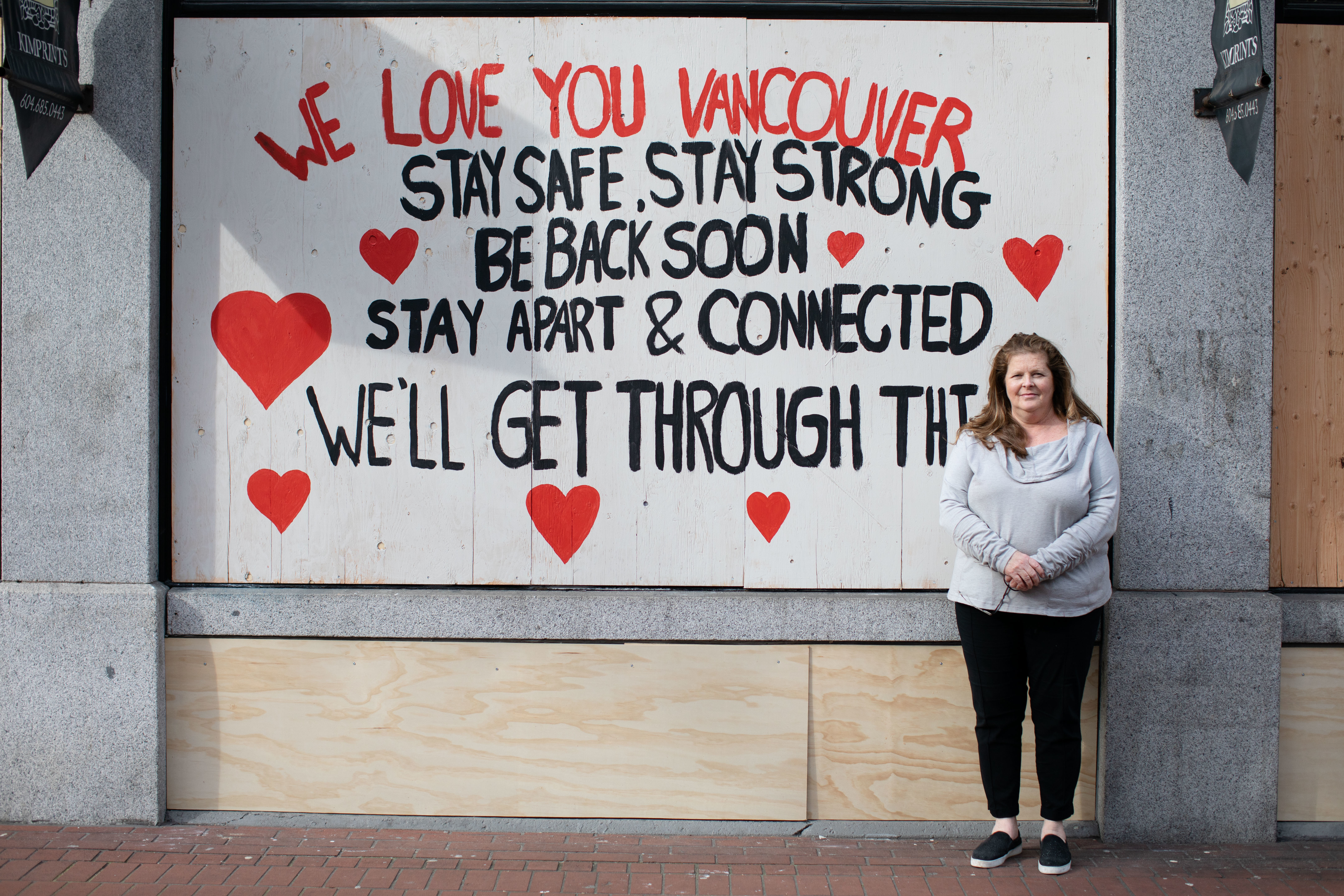 Kim Briscoe stands in front of the first completed mural. 