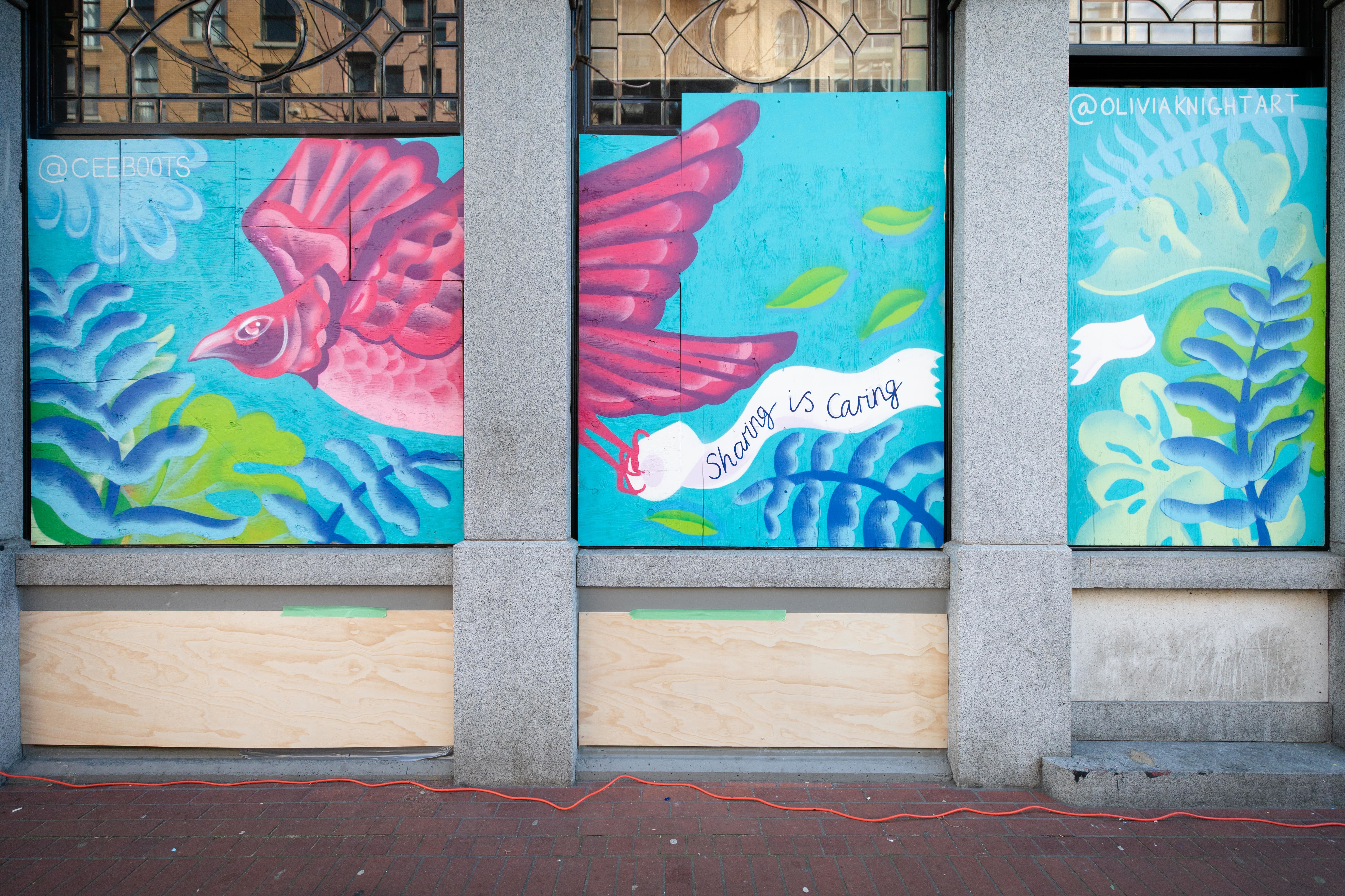 Hryc and Knight's mural shows a crow flying with a roll of toilet paper in its talons. The words 'Sharing is caring' are written on the toilet paper.