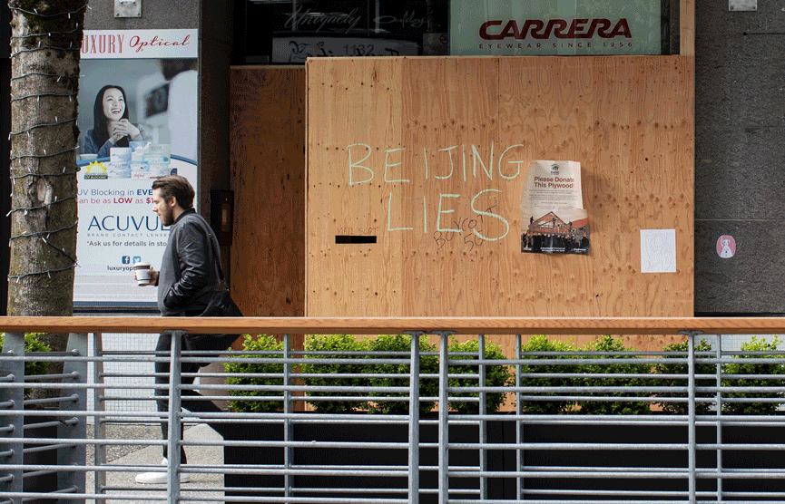 "Hang in there" and "keep going" messages are seen in the mural by artist Sandeep Johal on a boarded-up Luxury Optical storefront.