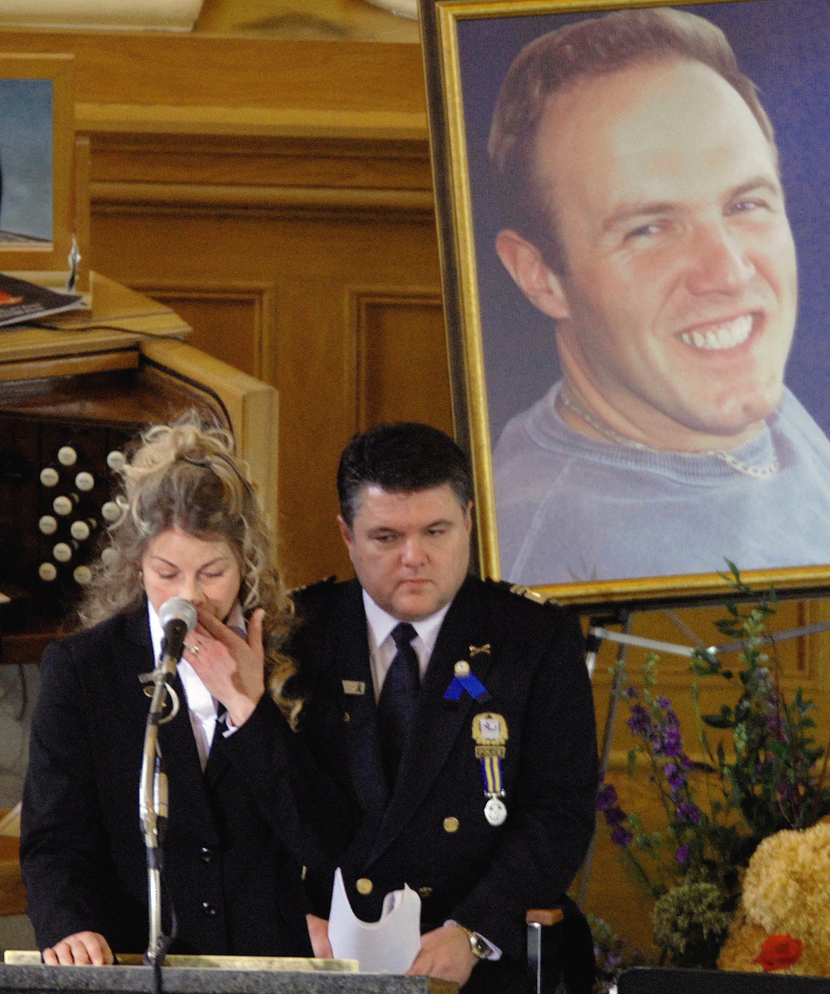 Dominique Lapointe, the widow of Laval police Sgt. Daniel Tessier, fights back tears at his funeral in March 2007. Tessier was shot dead during an early morning drug raid on a home in the Montreal suburbs. (The Canadian Press)