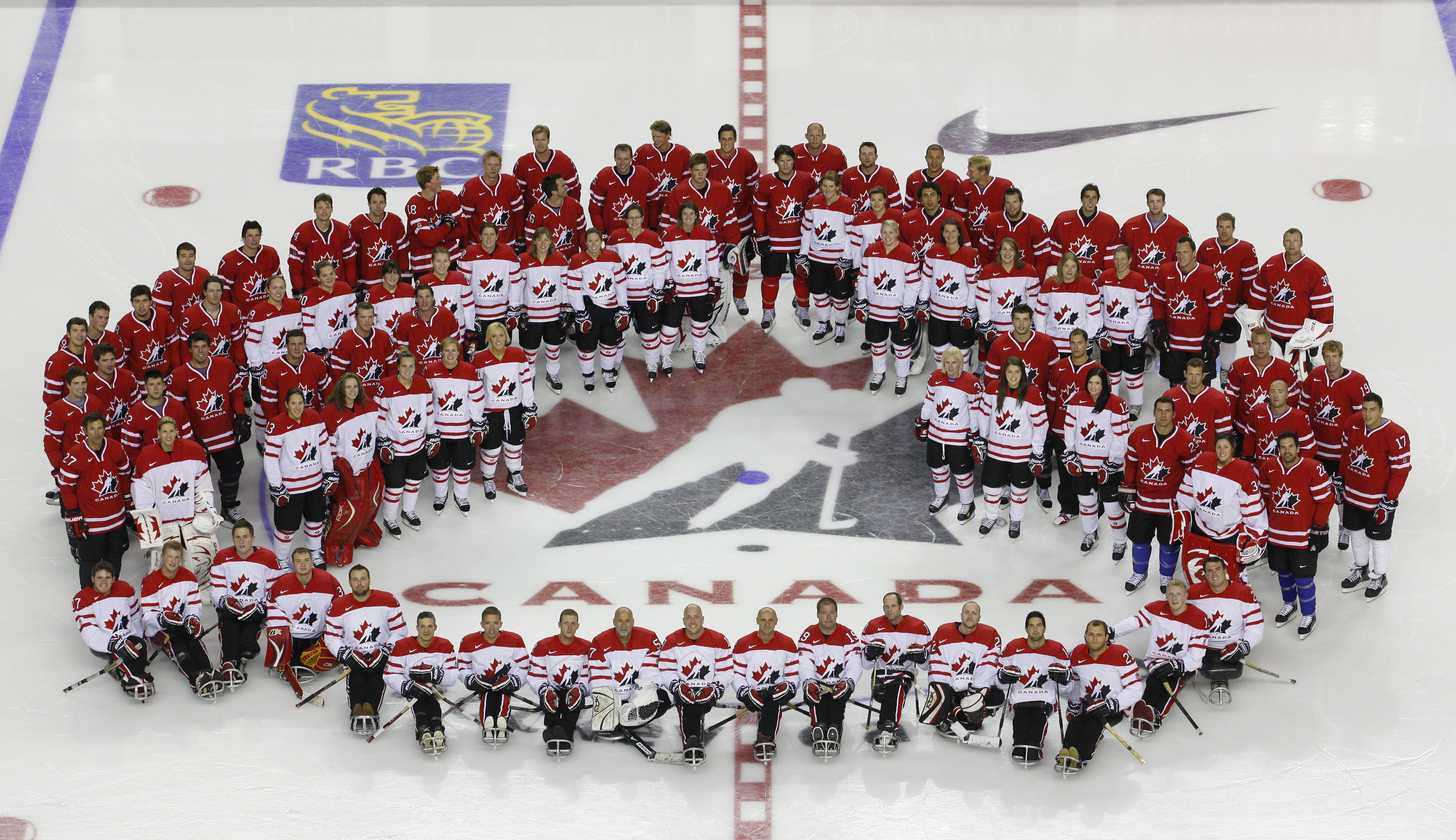 Members of Canada's Olympic men's, women's and sledge hockey teams pose for a photo during training camp in Calgary Aug. 26, 2009. For Canadian national hockey teams, expectations have always been high, but at the 2010 Olympics in Vancouver, they were even higher. (Todd Korol/Reuters)