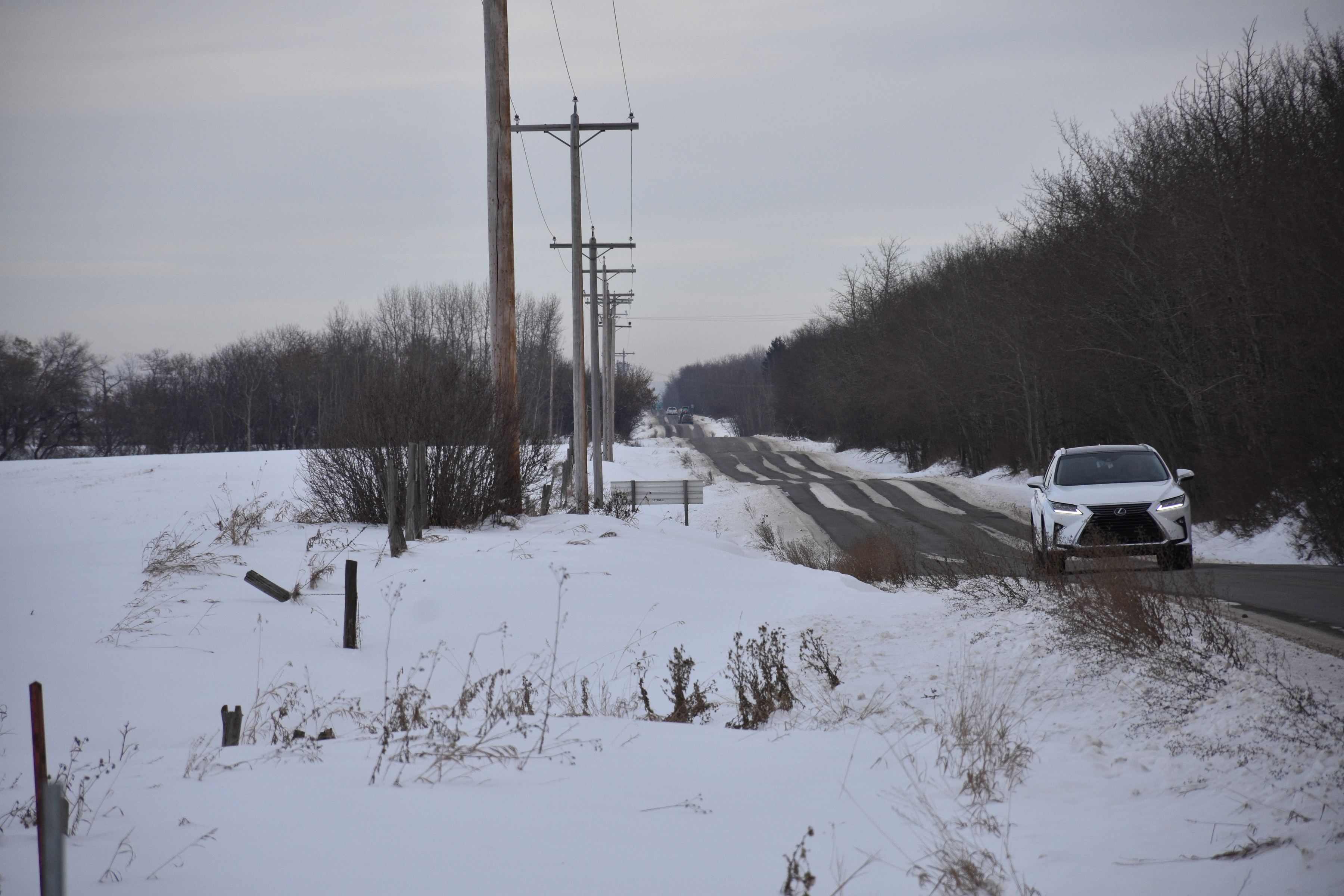 Many transgender patients take a five kilometre walk along this road to reach Dr. Makokis at the Enoch Health Centre. Buses from Edmonton only go as far as the River Cree Casino on the reserve's eastern edge. (Terry Reith/CBC)