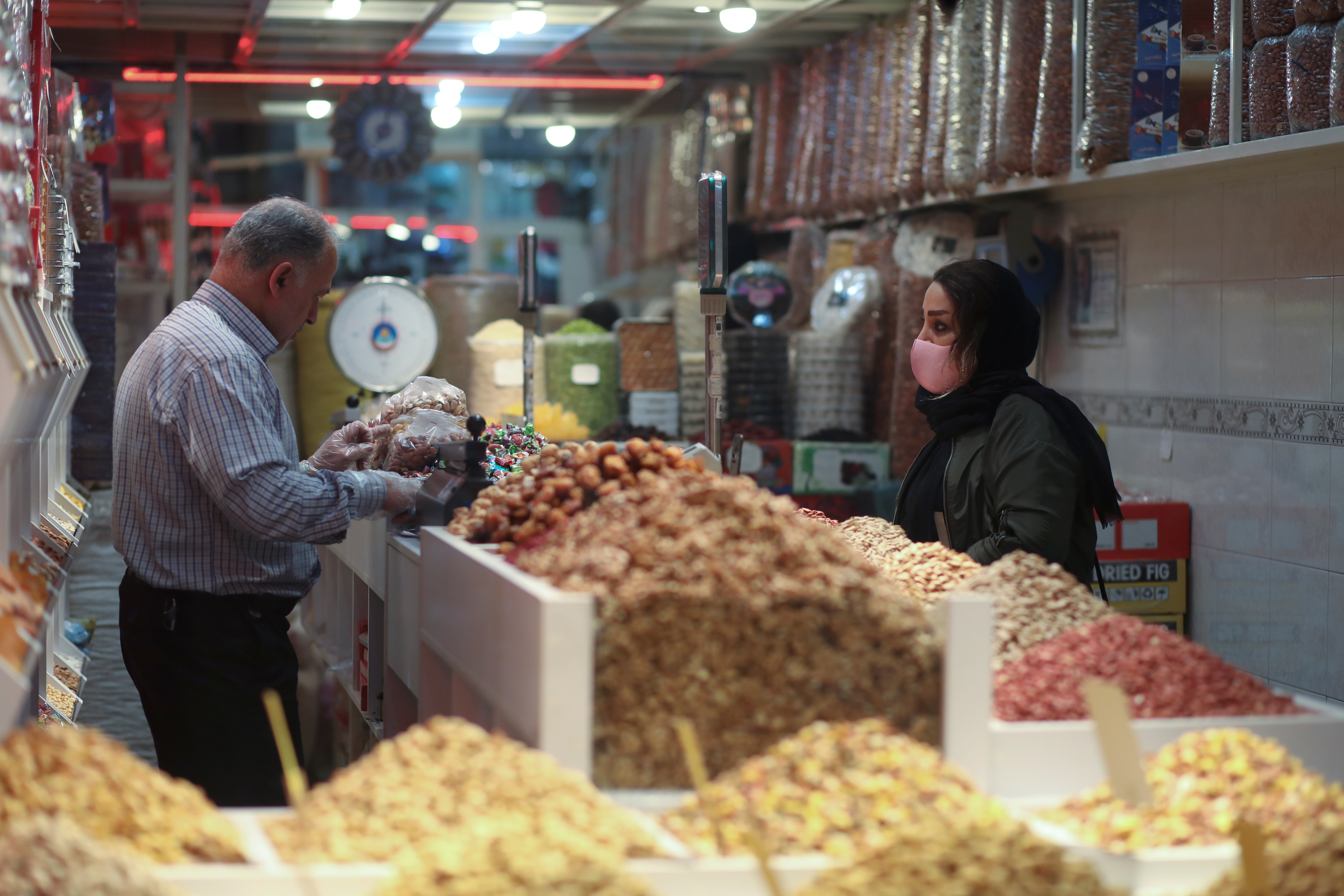 A woman wears a protective face mask during the COVID-19 pandemic as she shops at Tajrish Bazar in Tehran ahead of Nowruz in March 2021. (Ali Khara/West Asia News Agency/Reuters)