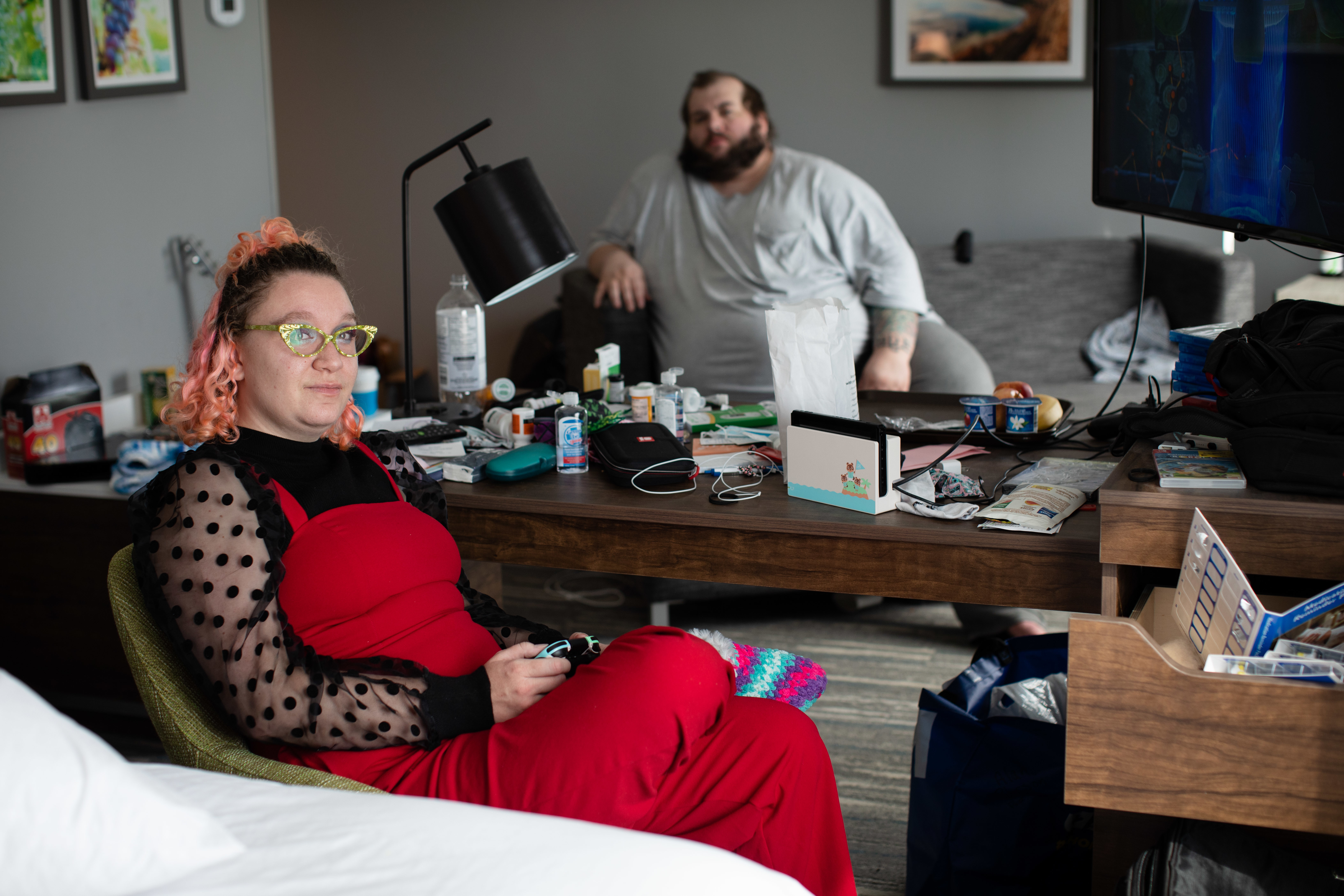 Wildfire evacuees Katja Burnett, left, and her husband, Al Peterson, are pictured inside a hotel room in Kelowna, B.C., on Sept. 2. (Maggie MacPherson/CBC)