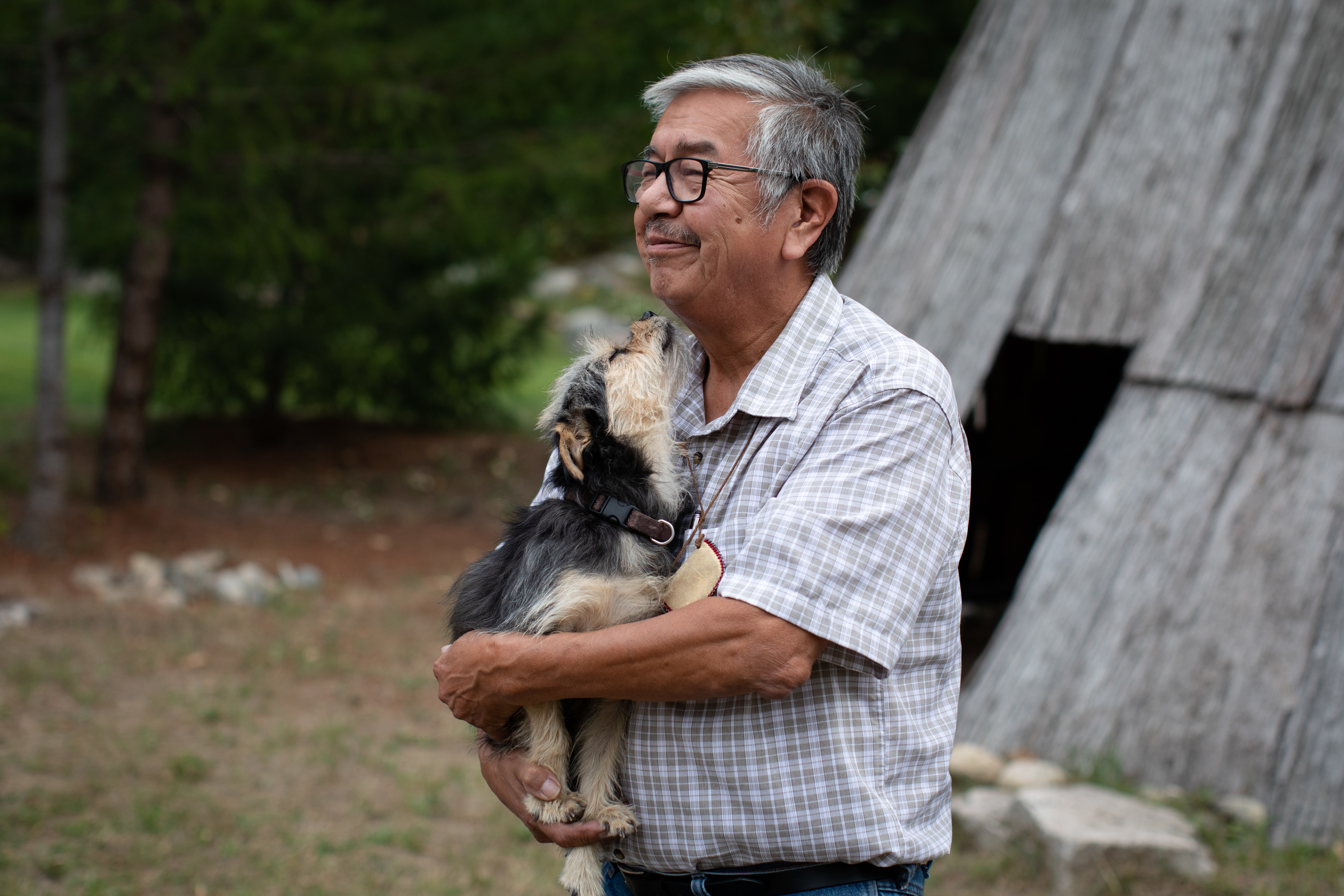 Byron Spinks, a member of Lytton First Nation, holds his dog, Baby, whom he lost during the wildfire and was reunited with weeks later, in Boston Bar, B.C., on Sept. 3. (Maggie MacPherson/CBC)