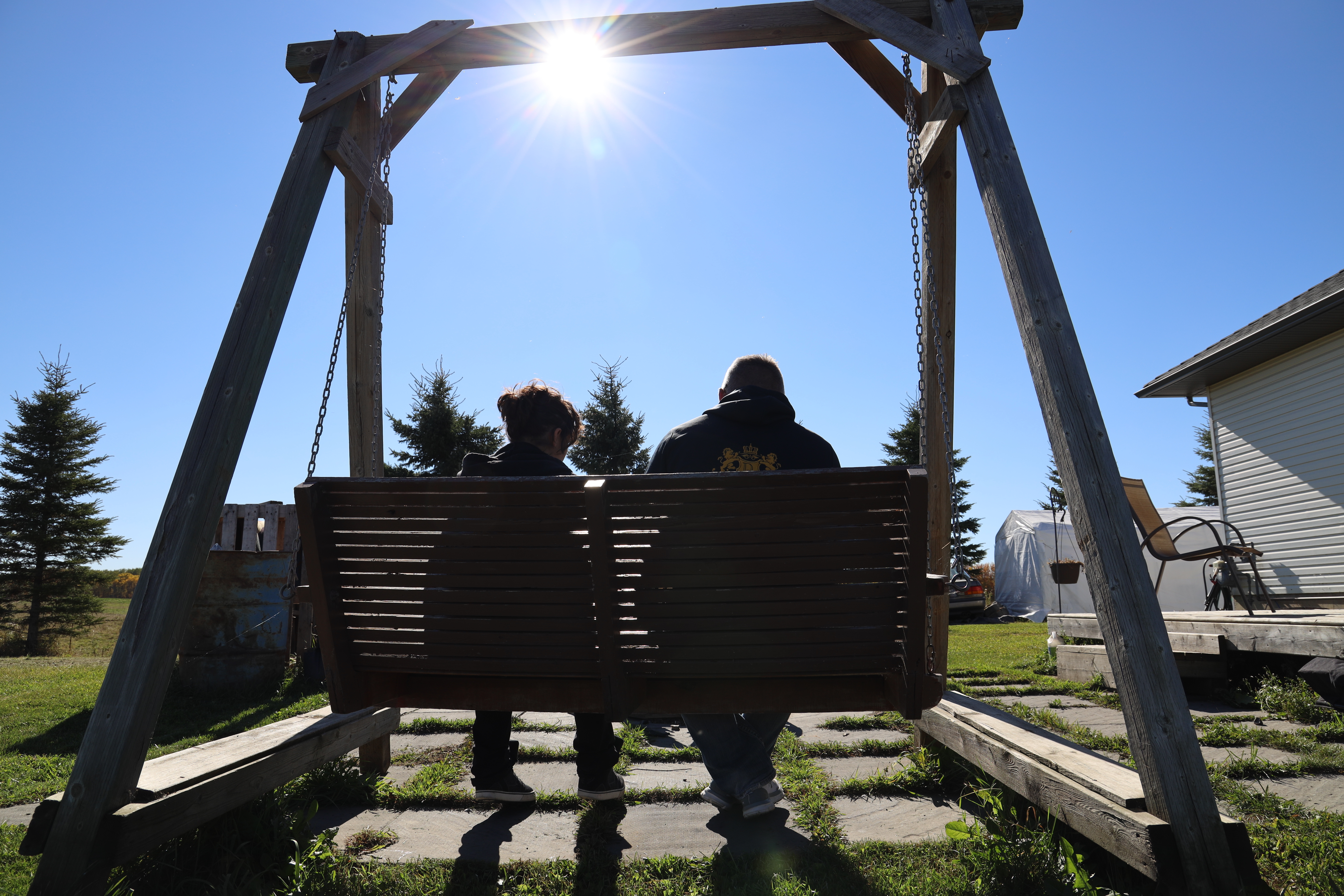 One of the alleged victims of Dominey sits with his fiancé on a rural property in Alberta. (Sam Martin/CBC)