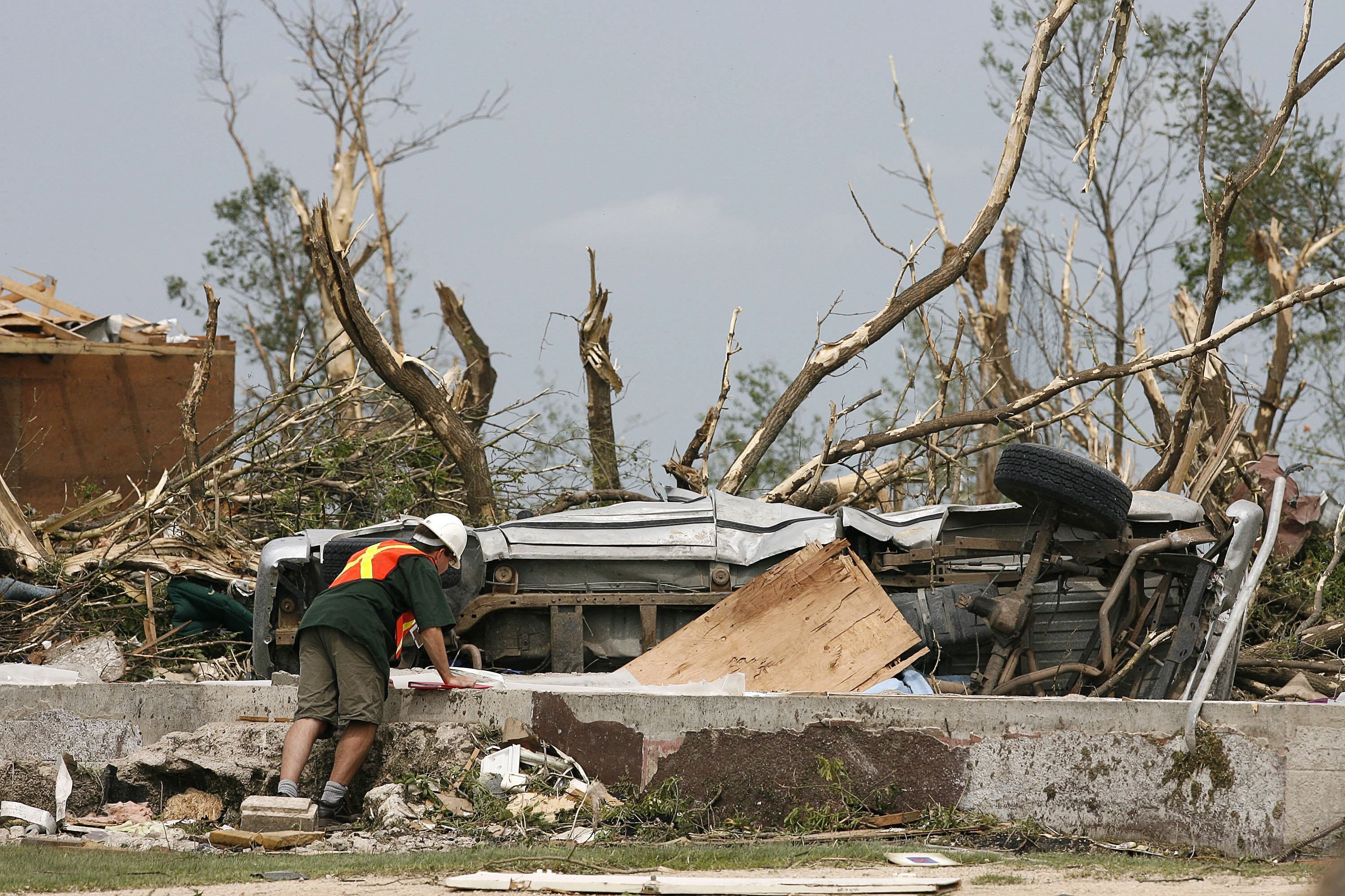 Environment Canada officials inspect the damage in Elie, Man., in June of 2007. An F5 tornado destroyed at least four homes and damaged several others, but there were no reports of injuries. (John Woods/Canadian Press)