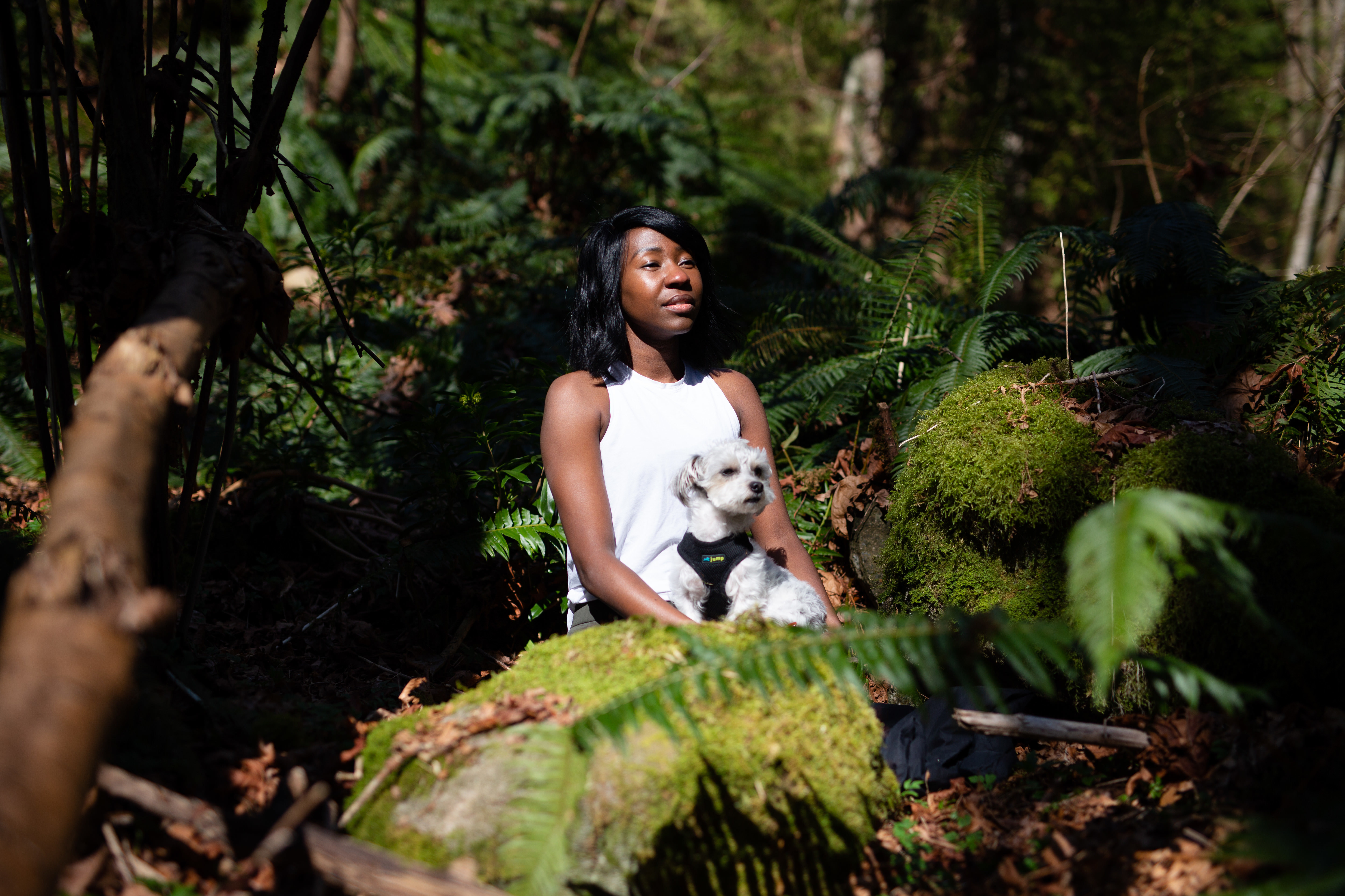 Nkomo meditates in the woods with her dog Hobbs. The forest is nice, but she says you can meditate anywhere.