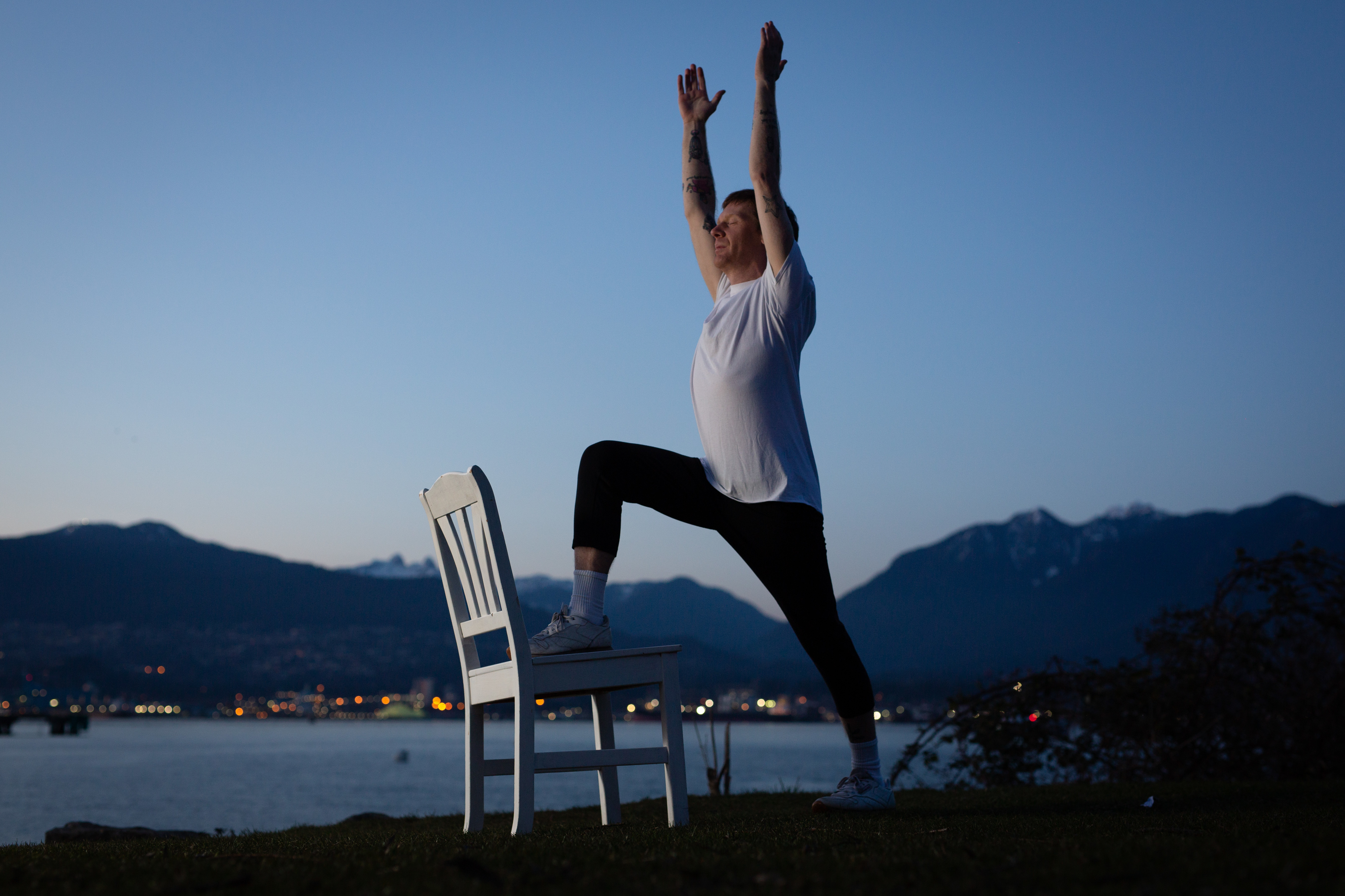 Tim Bang uses a chair to make yoga more accessible for students. 