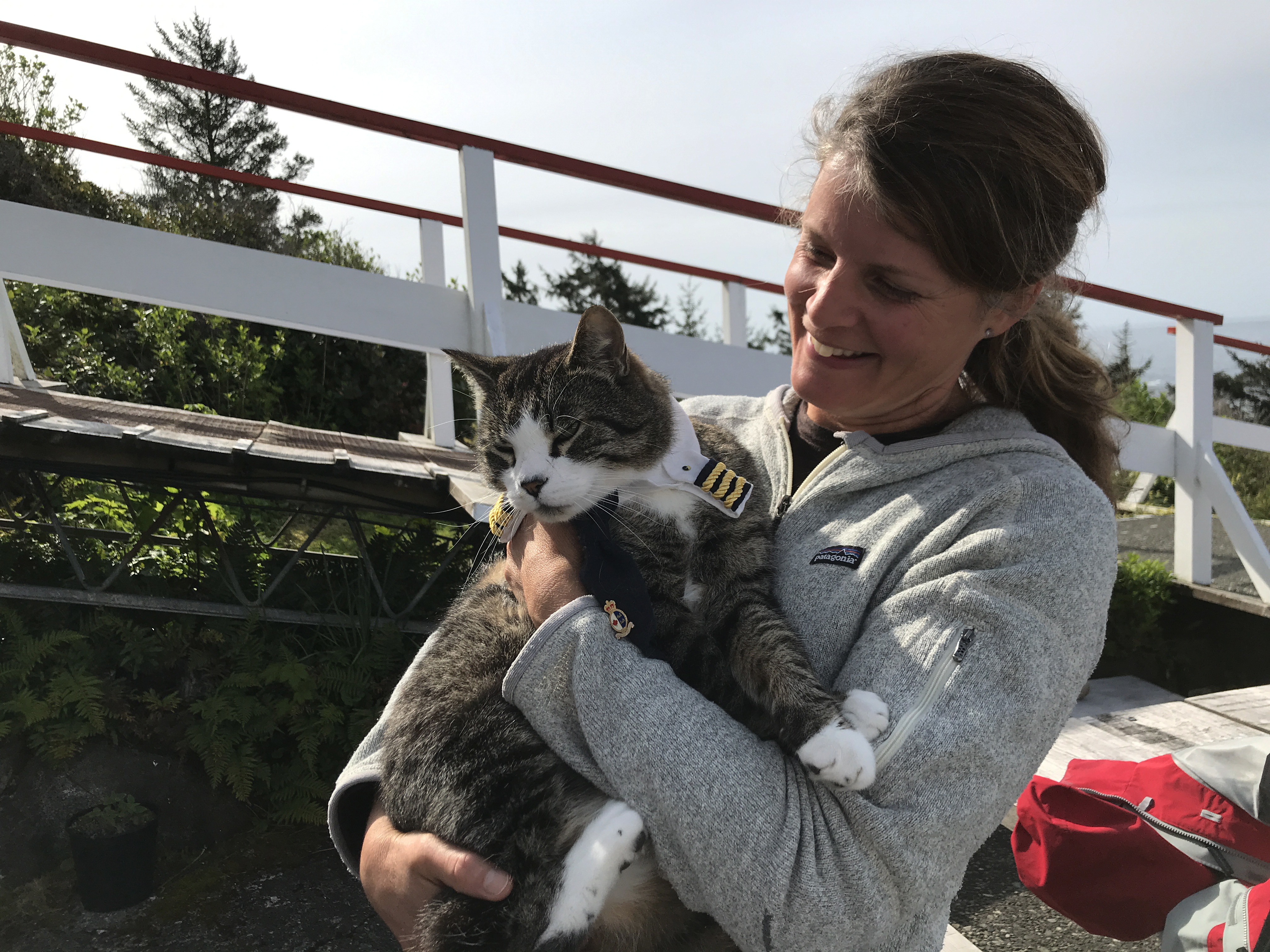 Zacharuk's cat Cash enjoys roaming the grounds of the lighthouse, and even has his own Canadian Coast Guard uniform. (Megan Thomas/CBC)