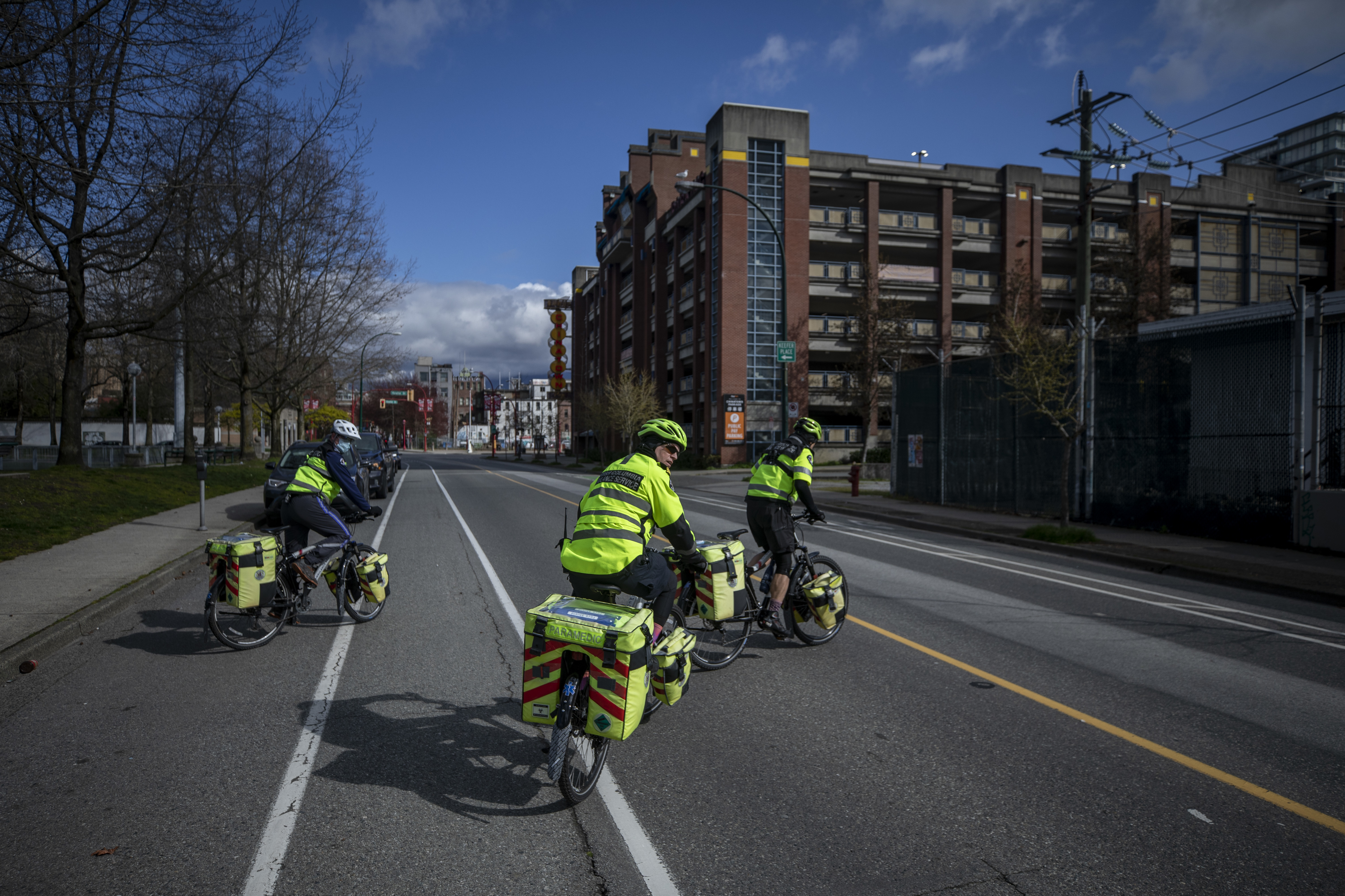 Left to right, Rodney Siudut, Darren Metta and Tom Venables, paramedics with the 248 Squad, cross Quebec Street in Vancouver on their way to an overdose call at the Carnegie Community Centre. (Ben Nelms/CBC)