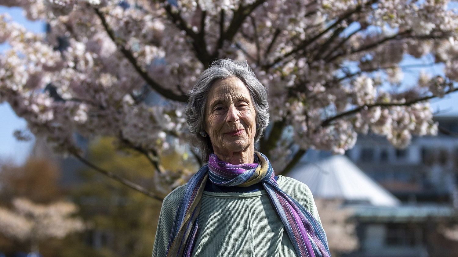 Aviva Martin, 73, is taking the time these days to slow down, smell the flowers, and reflect on how this moment fits into history. (Ben Nelms/CBC)