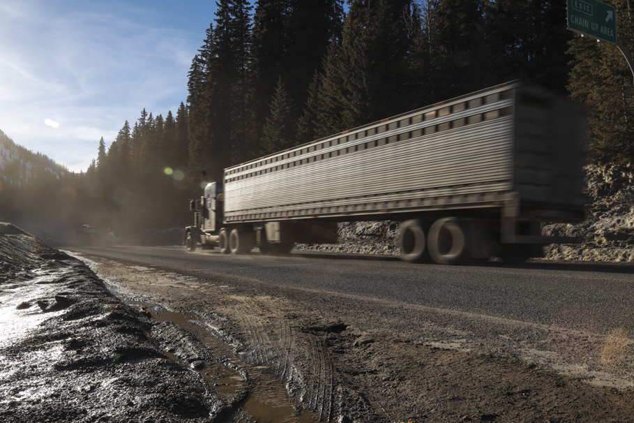 A truck drives through the Kootenay Summit, estimates are when a natural avalanche shuts down the highway it costs the economy $500,000 an hour. (Tina Lovgreen/CBC)