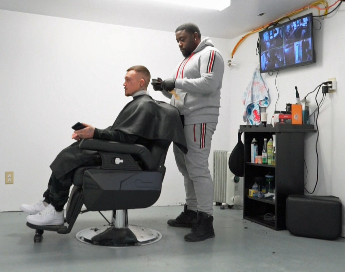 A barber shop in Dartmouth sits in a windowless basement of a clothing store owned by a man who has also served time in prison. (Sherry Vivian/CBC)