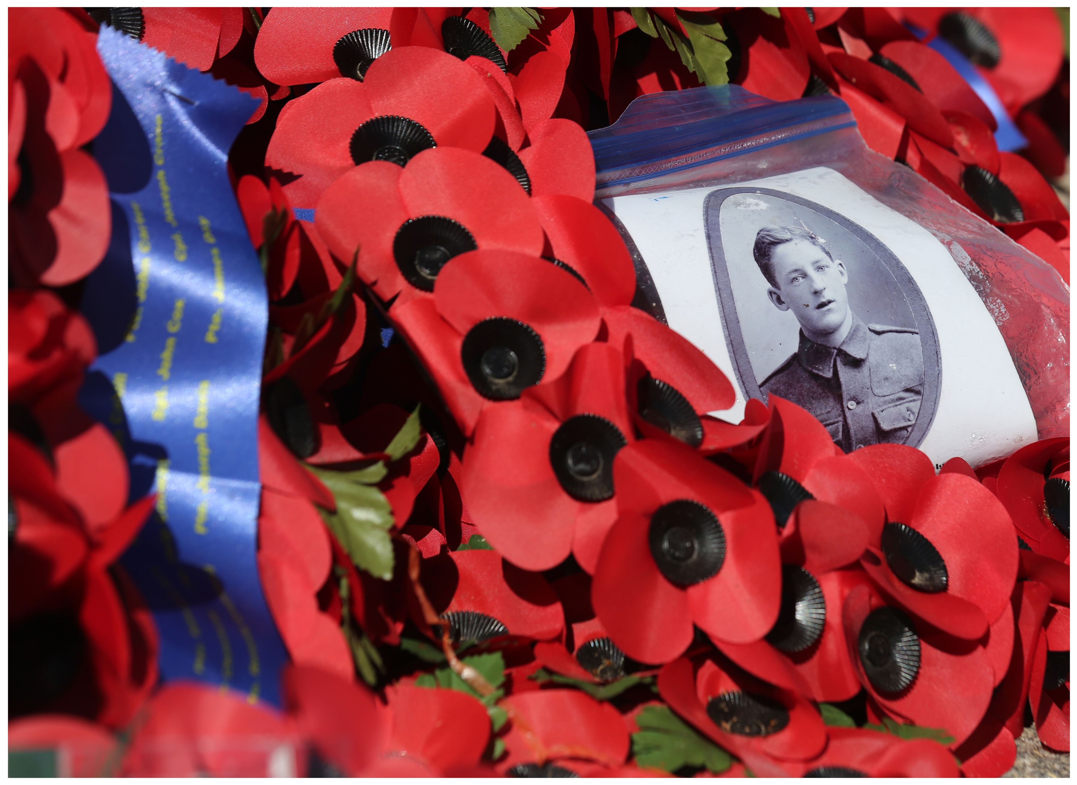 A picture of a young soldier was left within the wreaths and poppies at the Wall of Remembrance, at the foot of the Caribou in Beaumont-Hamel. (Paul Daly) 