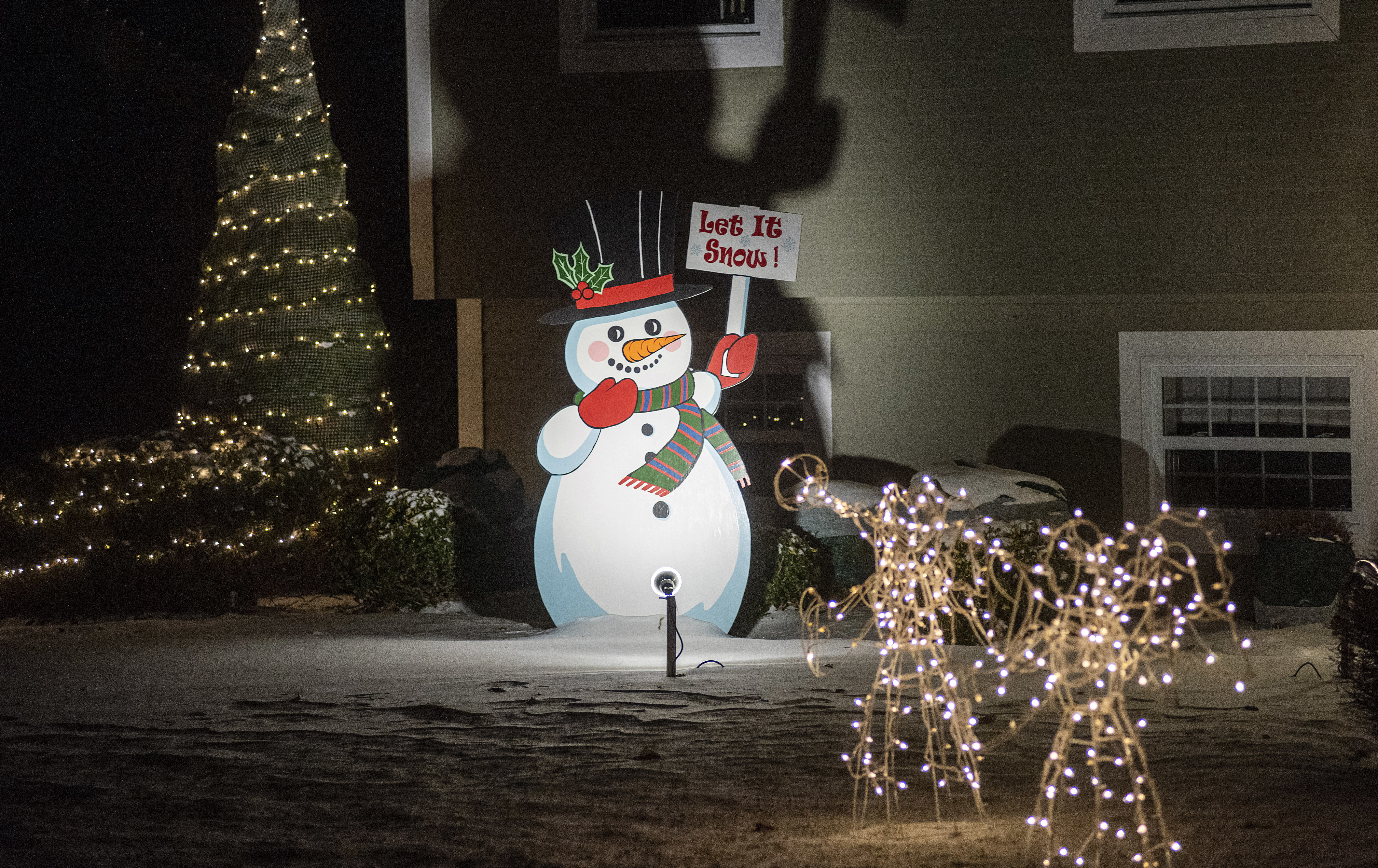 Fourteen residents along Upper Meadow Bank Road decided to make Frosty the Snowman the centre of attention on their lawns this Christmas. Most of the Frosties have a different message on the sign. (Brian McInnis/CBC)