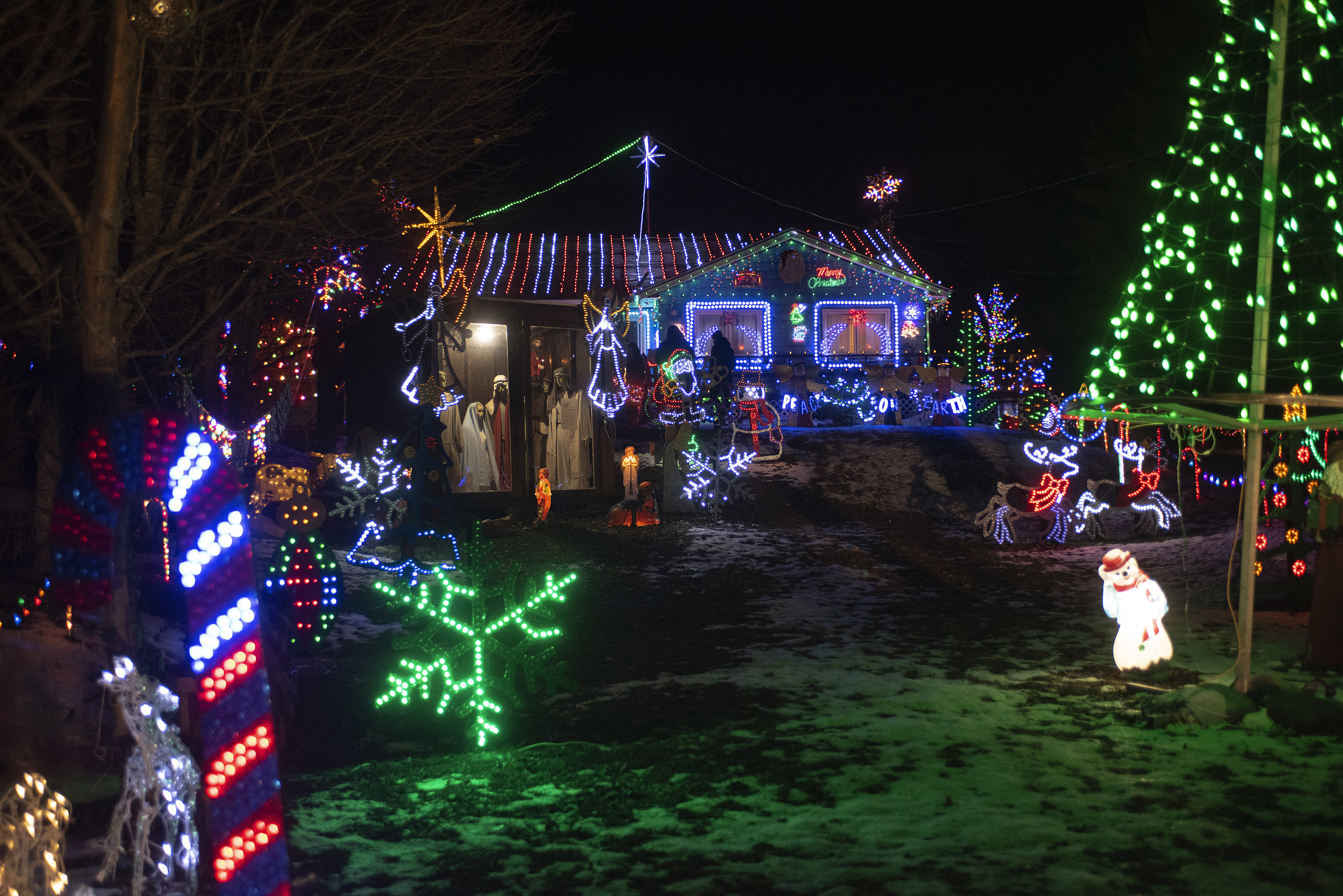 The residents of North Rustico know no boundaries when it comes to decorating their homes for Christmas. Fourteen years ago, James Gallant decorated his house as a way to try to get over the death of his son. It morphed into what today is a spectacular light show. The manger scene, left, was damaged by vandals earlier this month so the village came together to help Gallant repair the damage. (Brian McInnis/CBC)