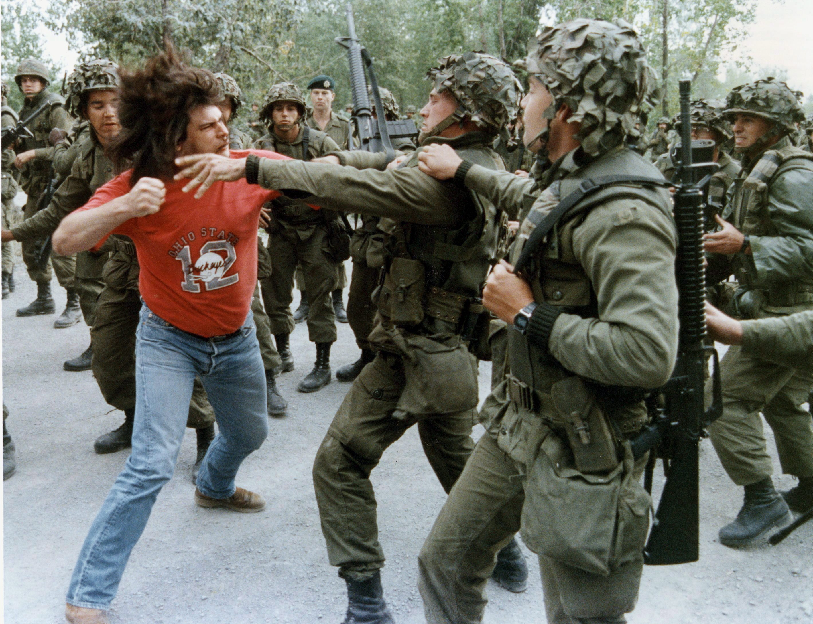 In this famous photo, Danny Phillips, a resident of Kahnawake, winds up to punch a soldier during a fight that took place in Kahnawake on Sept.18, 1990. (Tom Hanson/The Canadian Press)