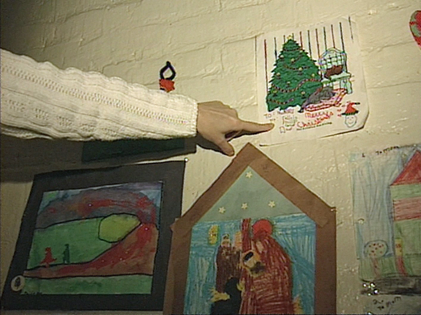 Loretta Pynn points to a colouring sheet given to her by Philip, daughter Felicia, and her husband, Phil Pynn Sr. (CBC)