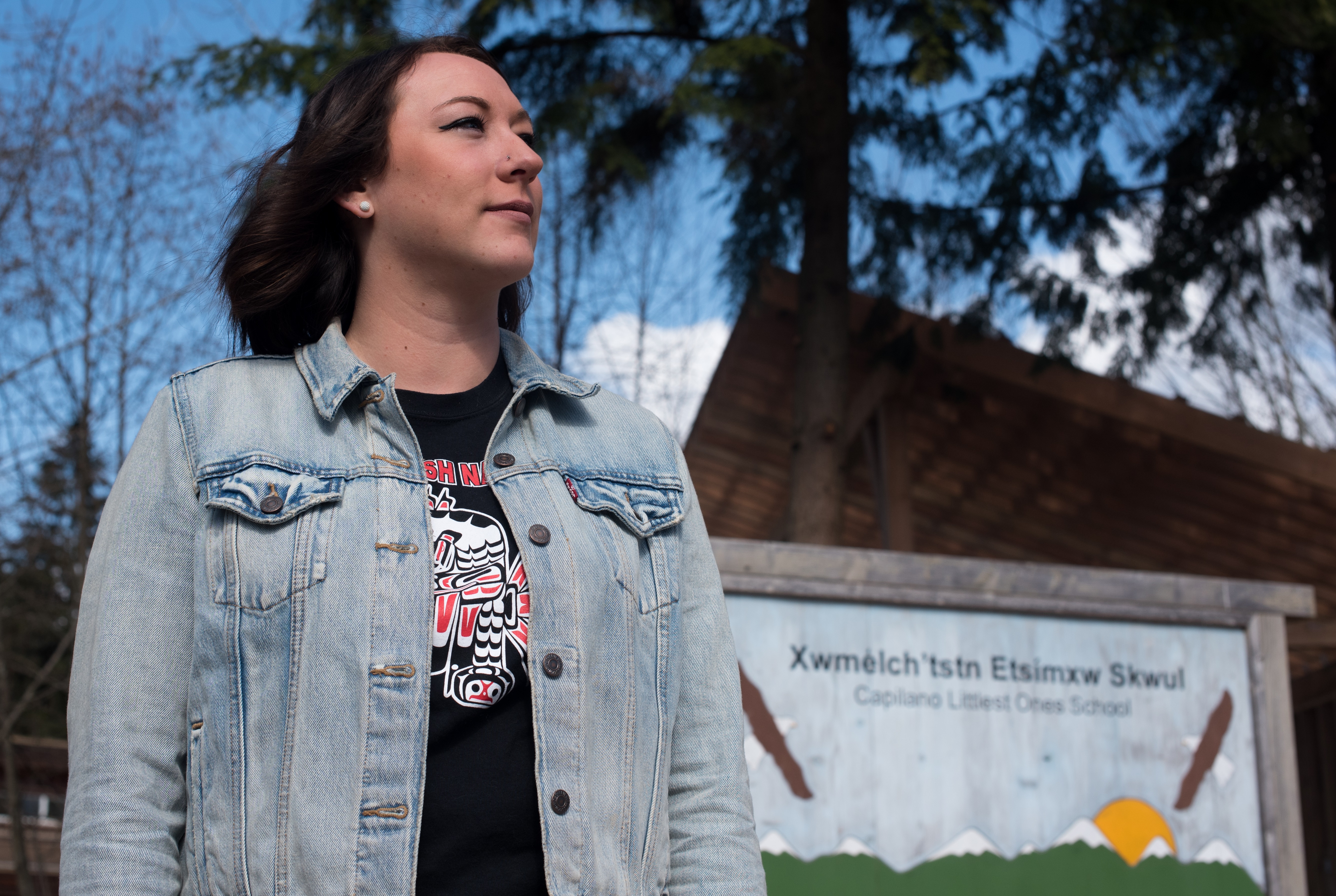 Carey McReynolds, a graduate of last year's Skwomesh immersion course at Simon Fraser University, stands in front of Capilano Littlest Ones School, where she currently works. (Dustin Patar/Marc Fawcett-Atkinson)