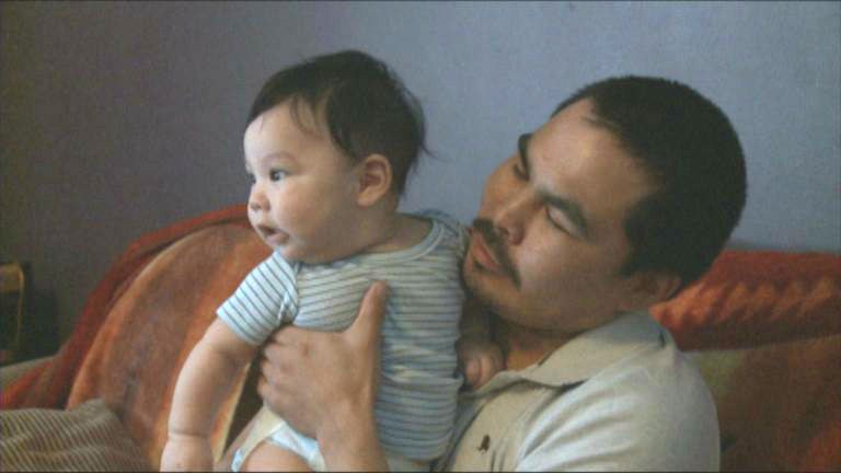 Chesley Ittulak holds his infant son, in this photo taken in 2013. (CBC)