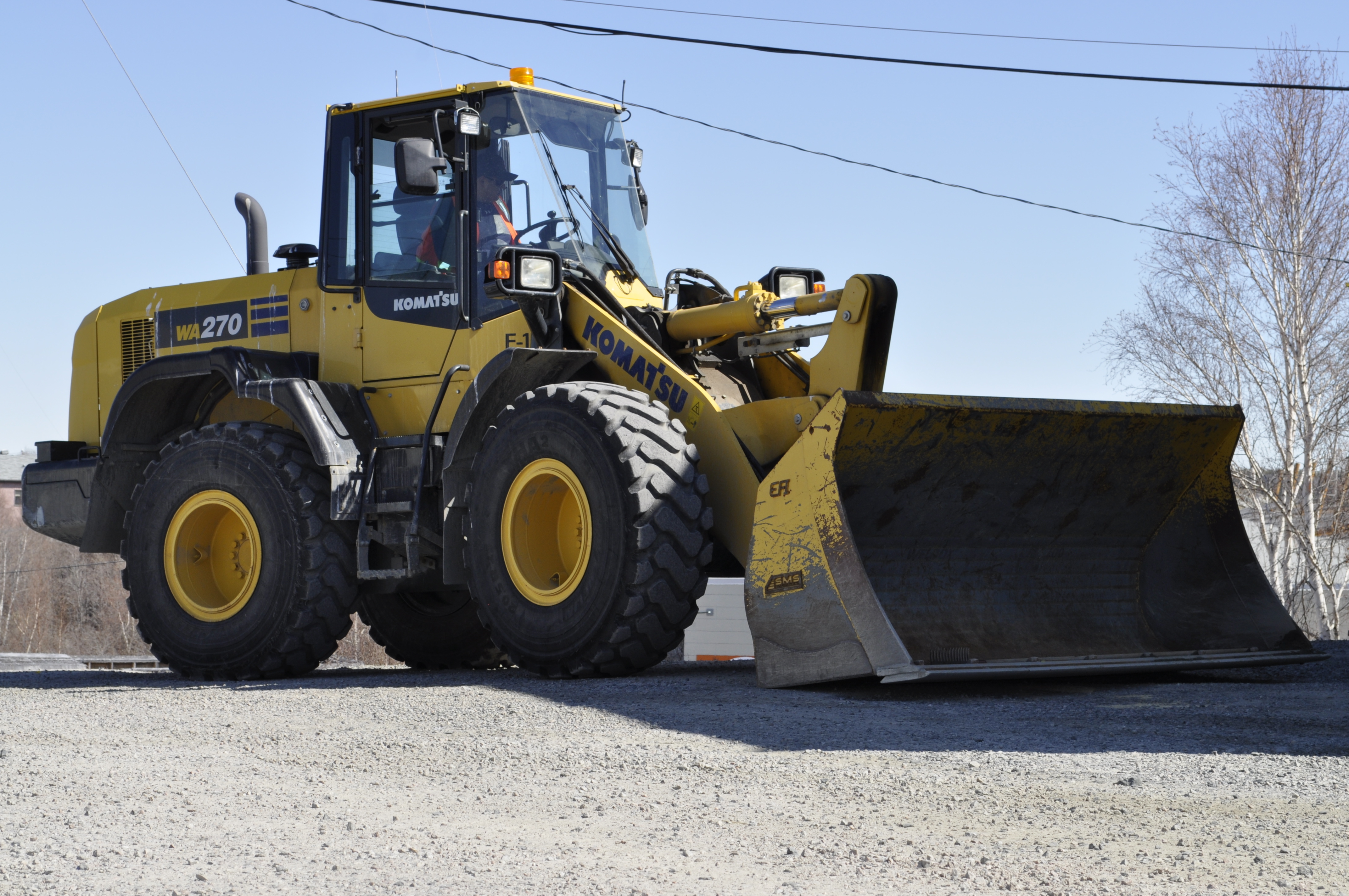 Paul Betsina operates a loader at the Det'on Cho facility in Ndilo. The business arm of the Yellowknives Dene is itself a major employer in the territory. (Alex Brockman/CBC)