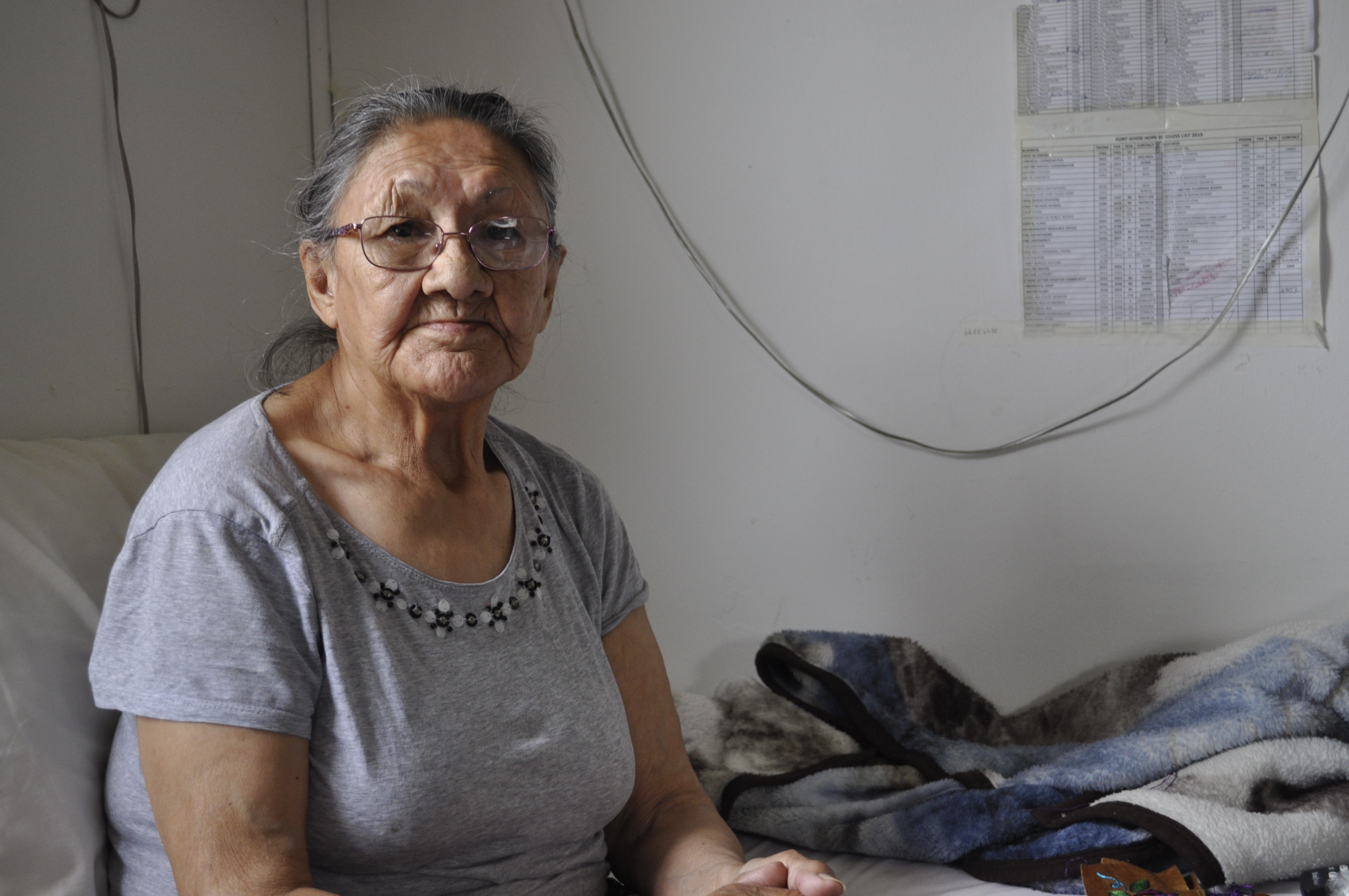 Margaret Kelly sits in her home in Fort Good Hope, N.W.T. She's done fighting the land and is ready to move out. (Alex Brockman/CBC)