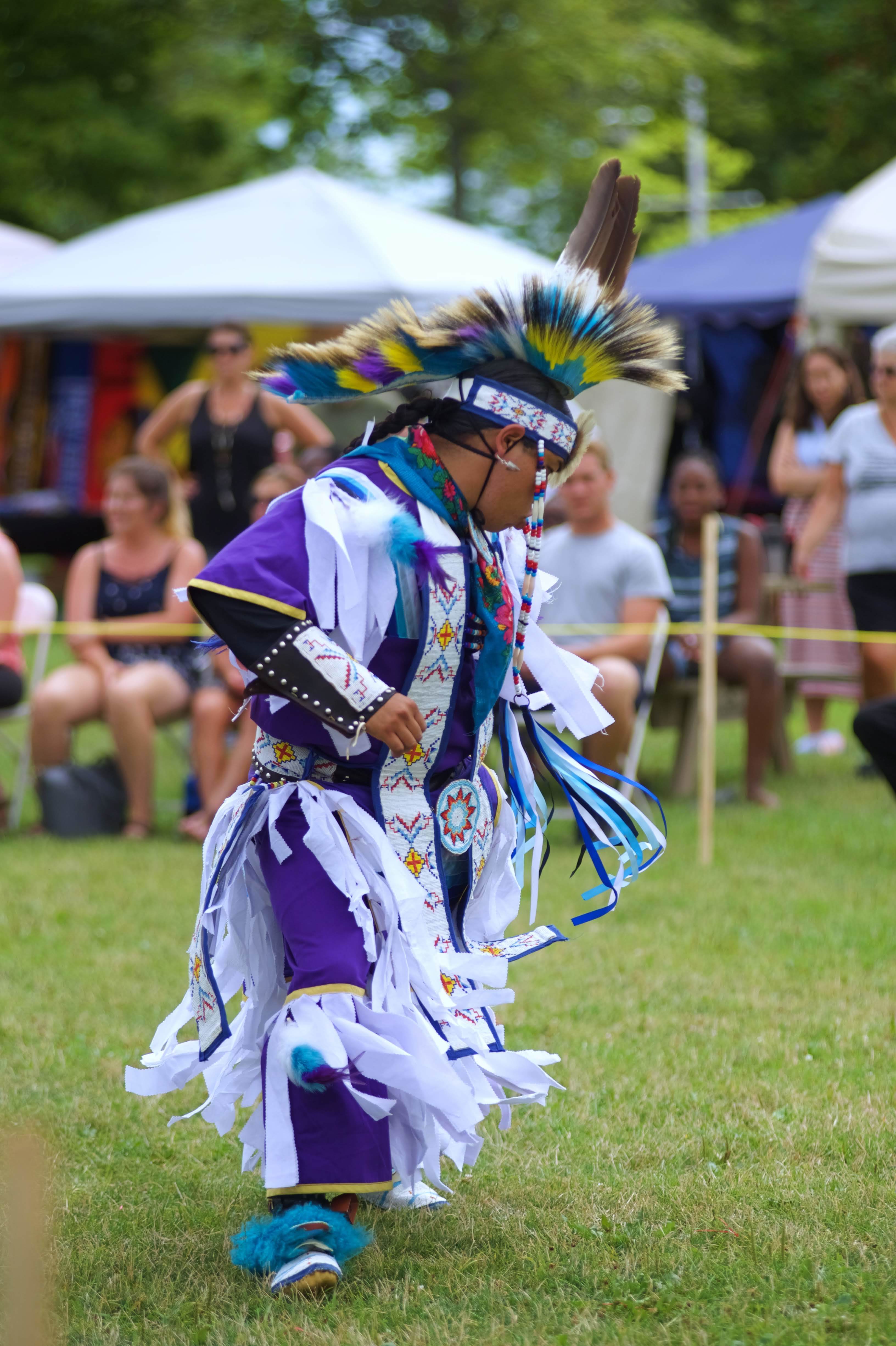 Just before the grand entry begins, you will see a dance performed by the Grass Dancers, this blesses and flattens the grass to prepare the land for dancing. On the final day when they do the exit, a grass dancer will exit and close the space. (Patricia Bourque)