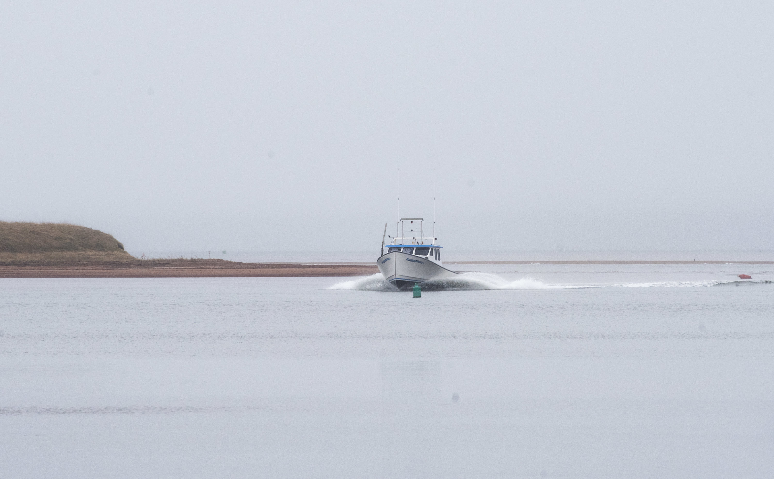 On the Rocks slides out of a morning fog as the captain guides her to the wharf in French River to unload her cargo of lobster. (Brian McInnis)