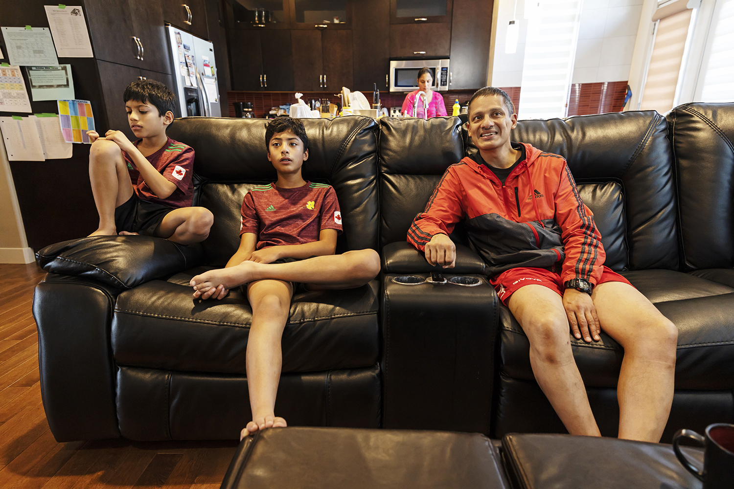 Jacob at home with his wife, Diya, and two children, Karl, middle, and Colin, after a field hockey training practice. 