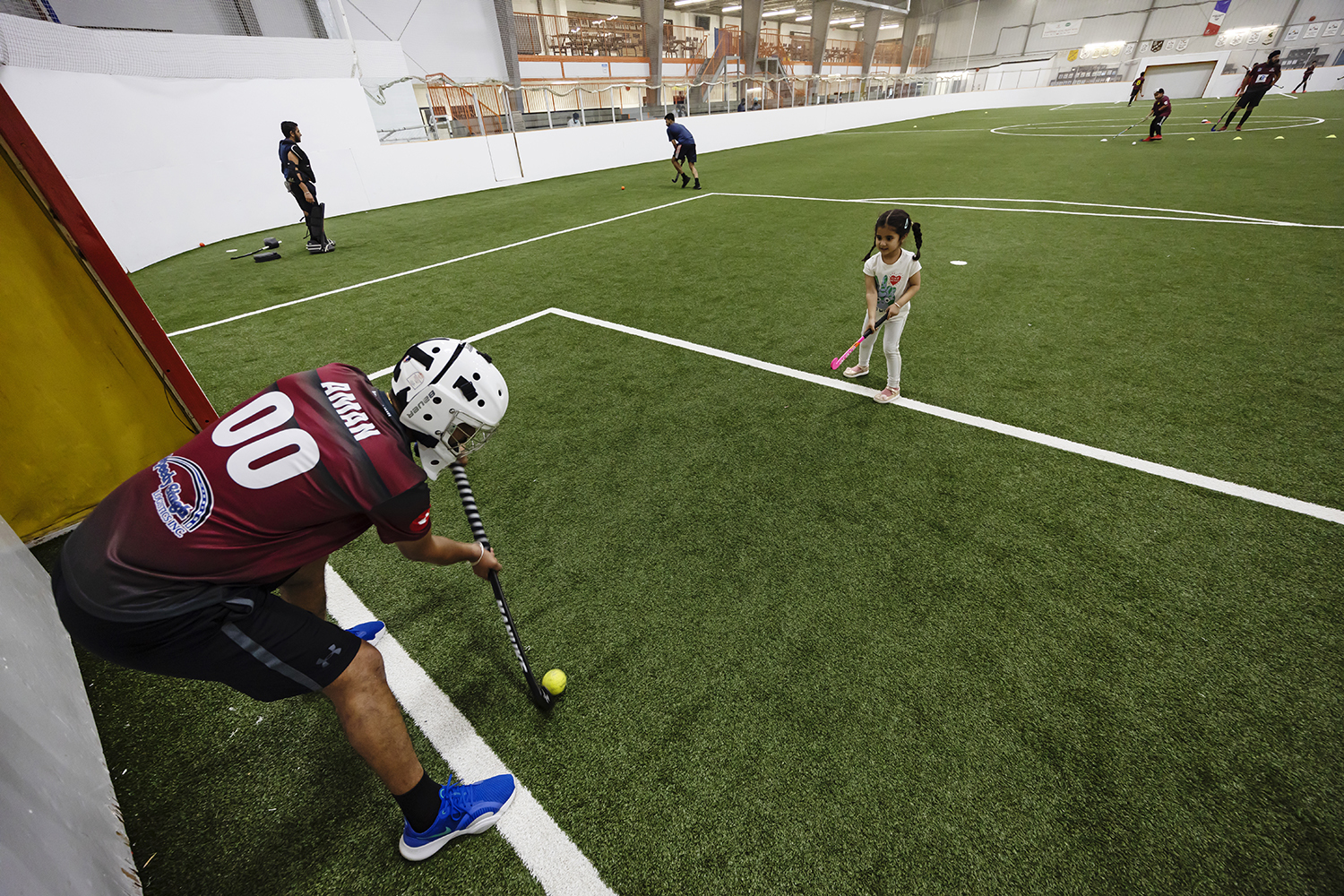 Tejinder Gill, one of the Rovers field hockey coaches, defends a goal against his three-year-old daughter, Gurmehar.