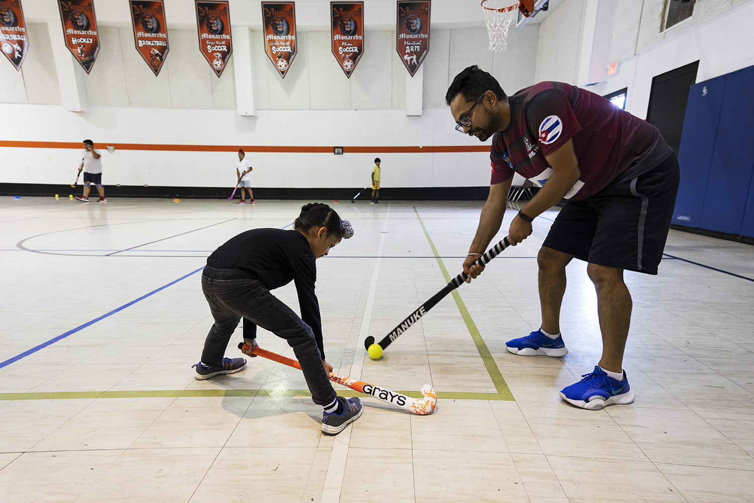 The Maples Community Centre in Winnipeg is a hockey nursery of sorts for young children to start learning field hockey skills before moving to the playing turf. Gill teaches a beginner student, Vikramjit Singh, 6.