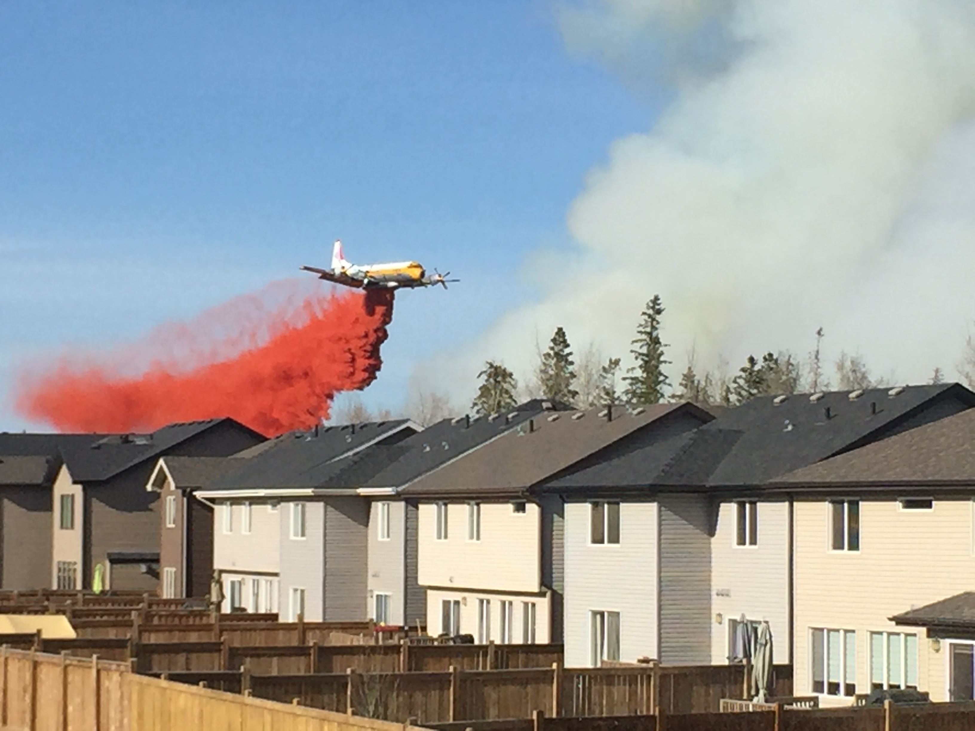 Dale Bendfeld was on his back deck in Fort McMurray when he took this cellphone photo of a water bomber on Sunday, May 1. (Dale Bendfeld)