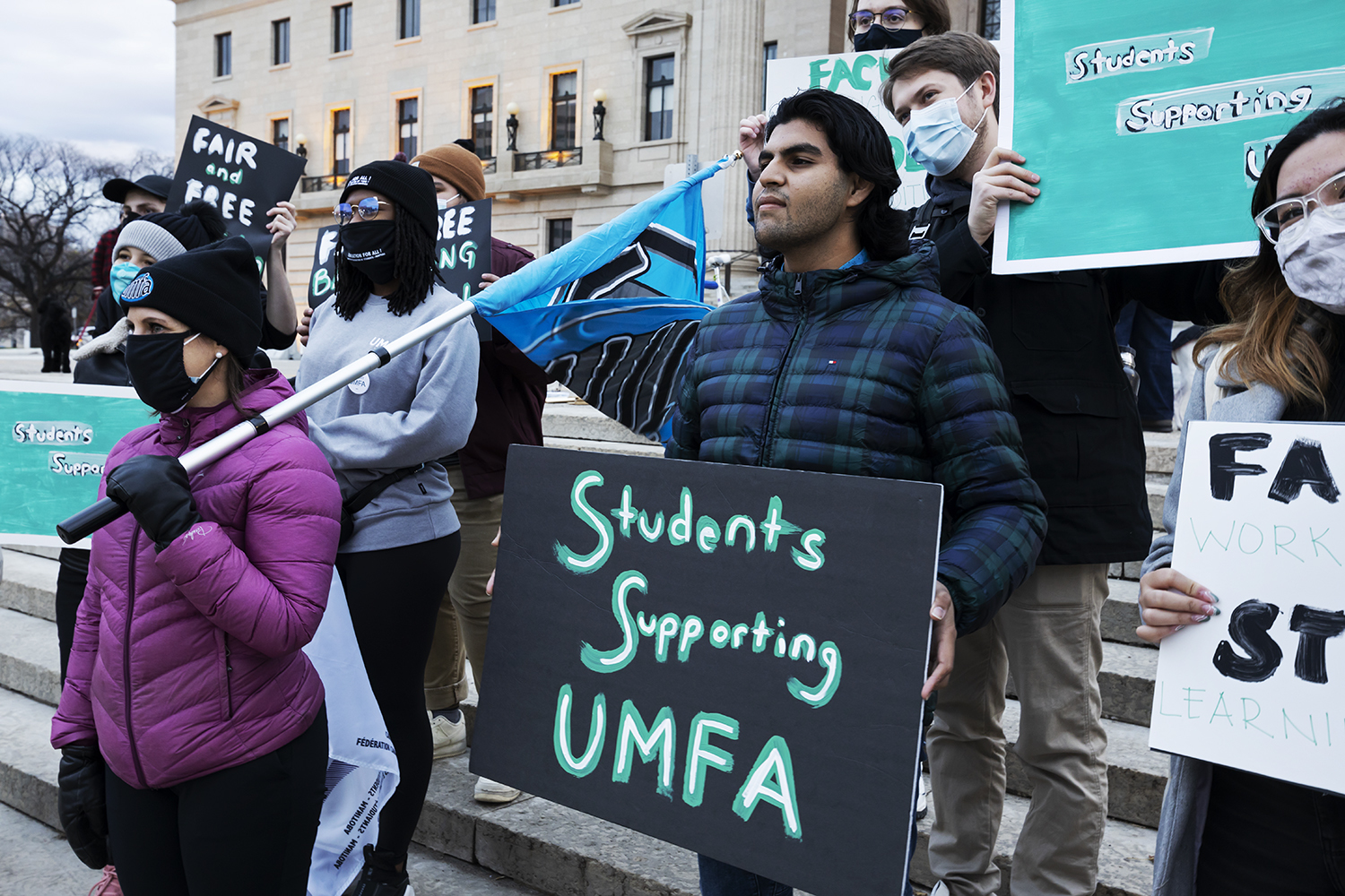 Samtani stands alongside fellow students protesting in support of striking U of M faculty at the Manitoba Legislature on Oct. 29. (Prabhjot Singh Lotey/CBC)