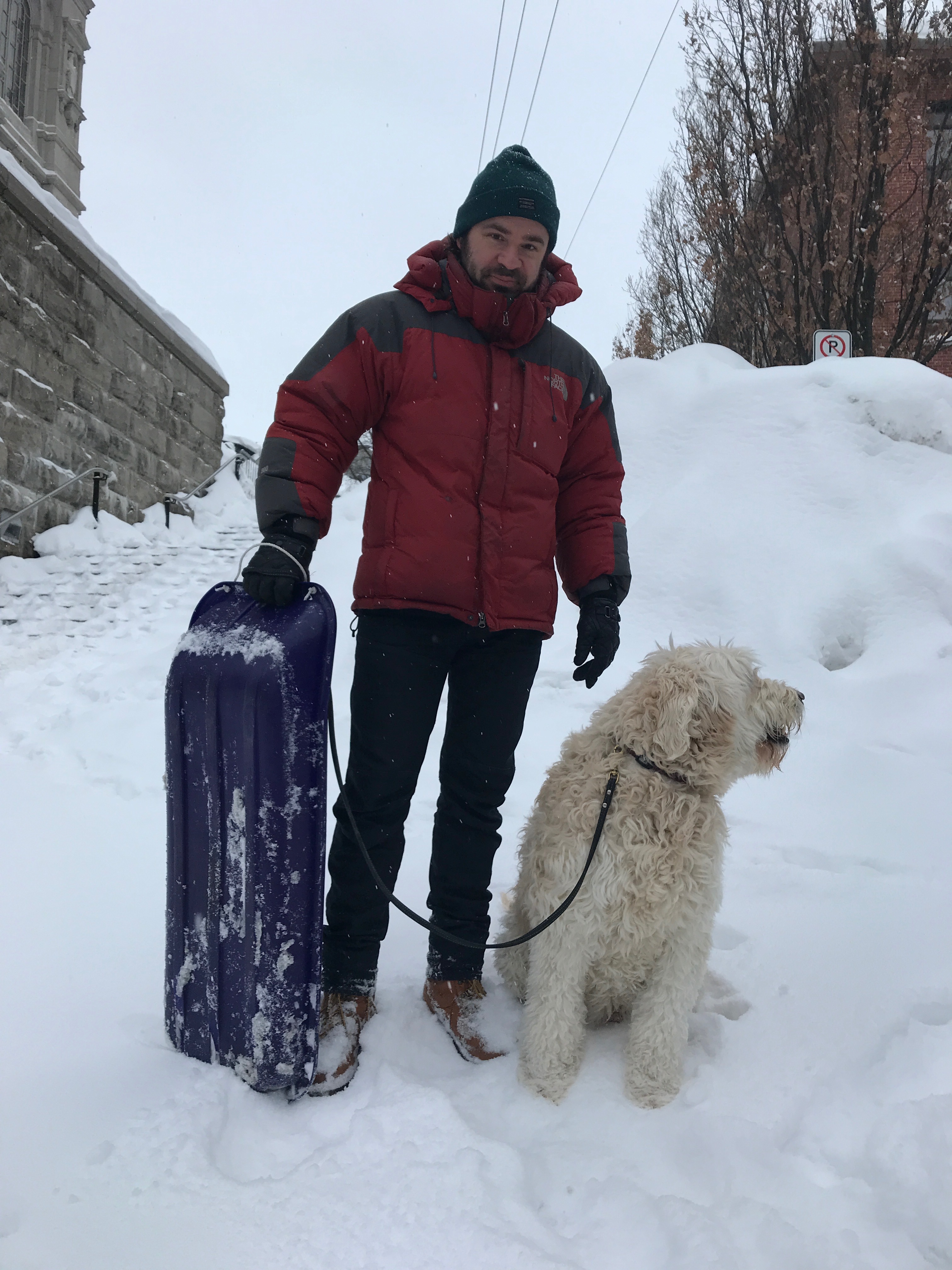 In the winter, Francis Simard's mornings involve walking his dog, Enzo, and carting his son to school in a sled. (Julia Caron/CBC)