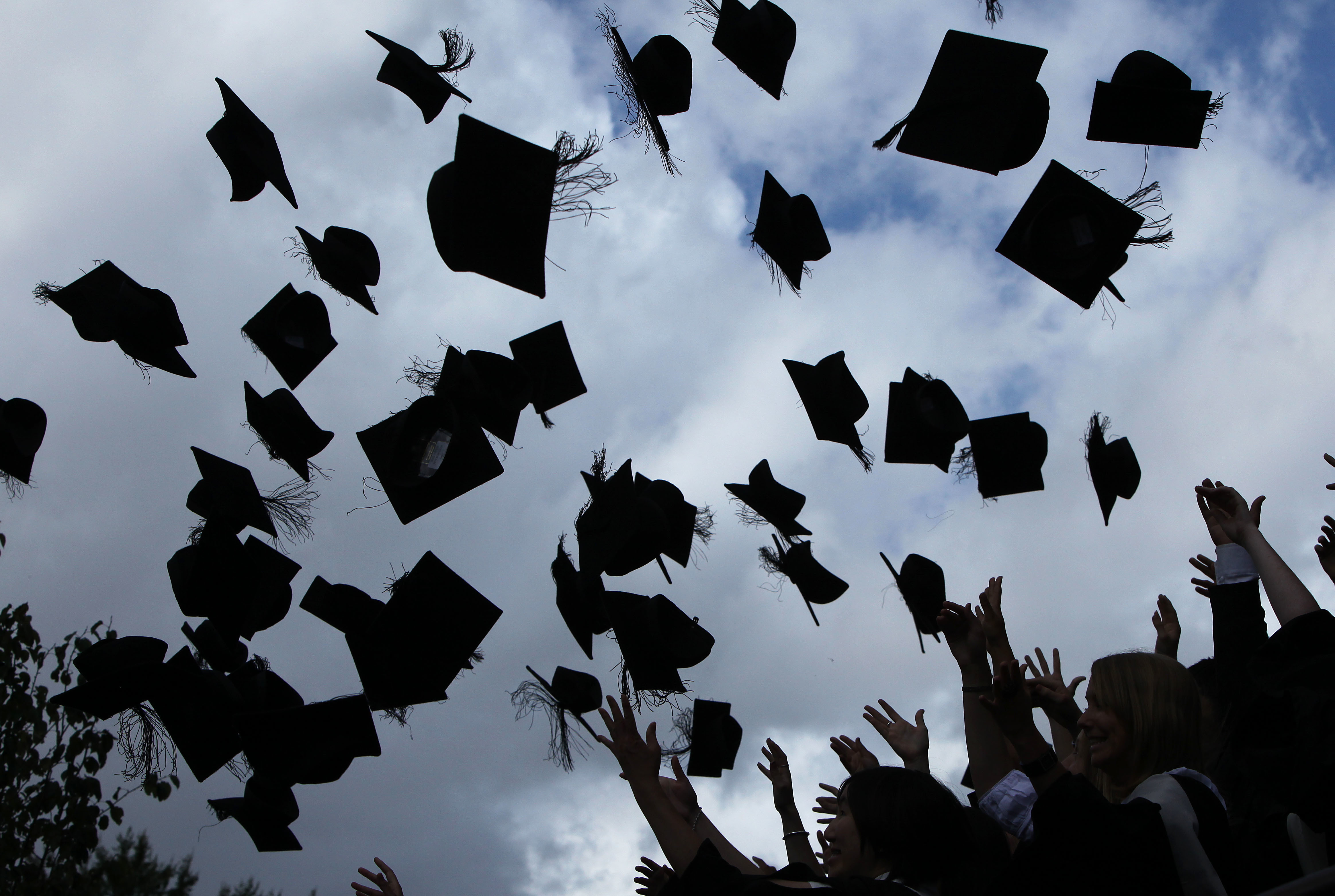 While students traditionally toss their hats in the air, this year most graduation ceremonies involved just one person at a time. Christopher Furlong/Getty Images