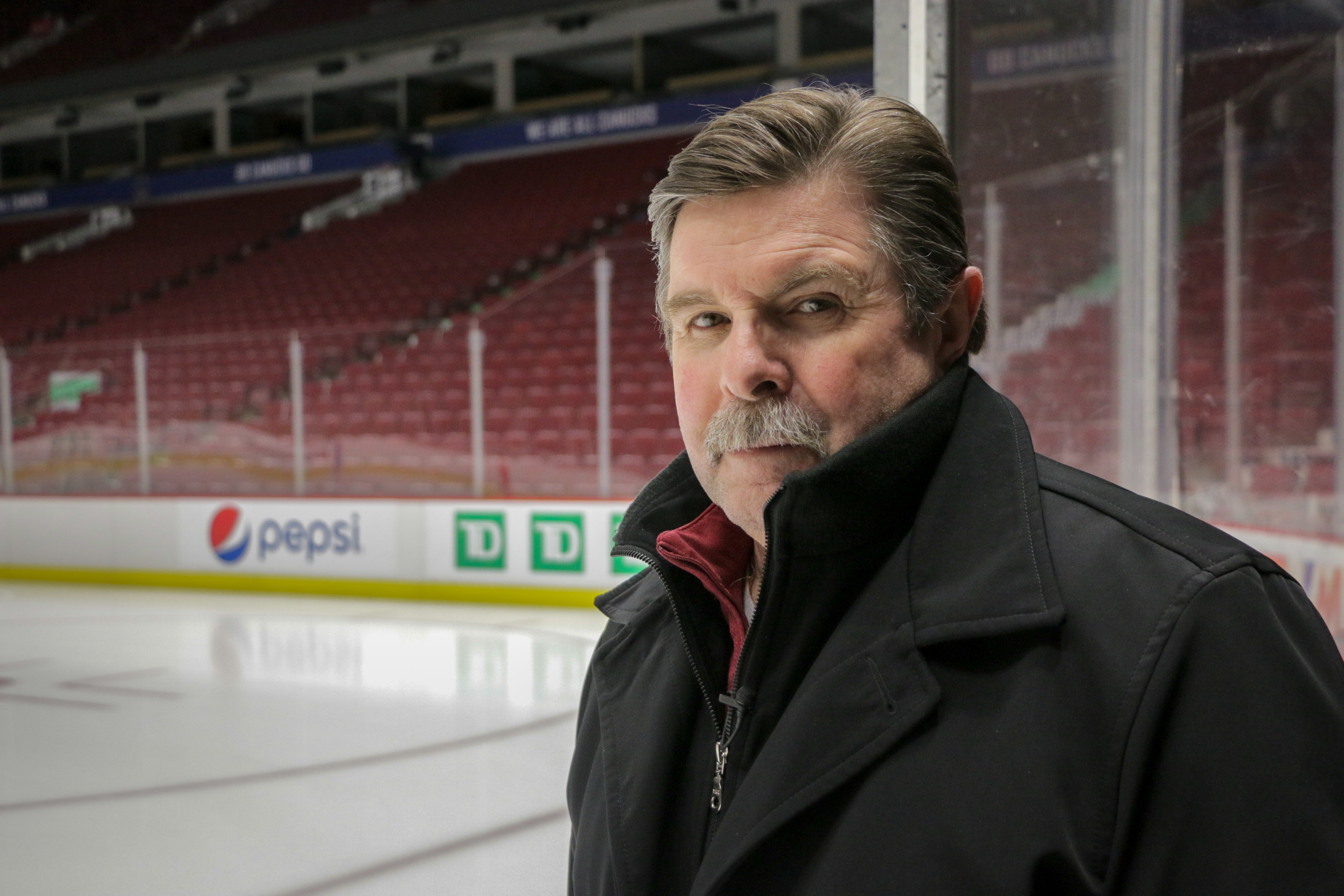 Referee Bill McCreary at Vancouver's Rogers Arena in 2019. During the 2010 Olympics, the arena was known as Canada Hockey Place. Over McCreary's right shoulder is the rink corner he was in when Sidney Crosby scored the golden goal. (Christian Amundson/CBC)