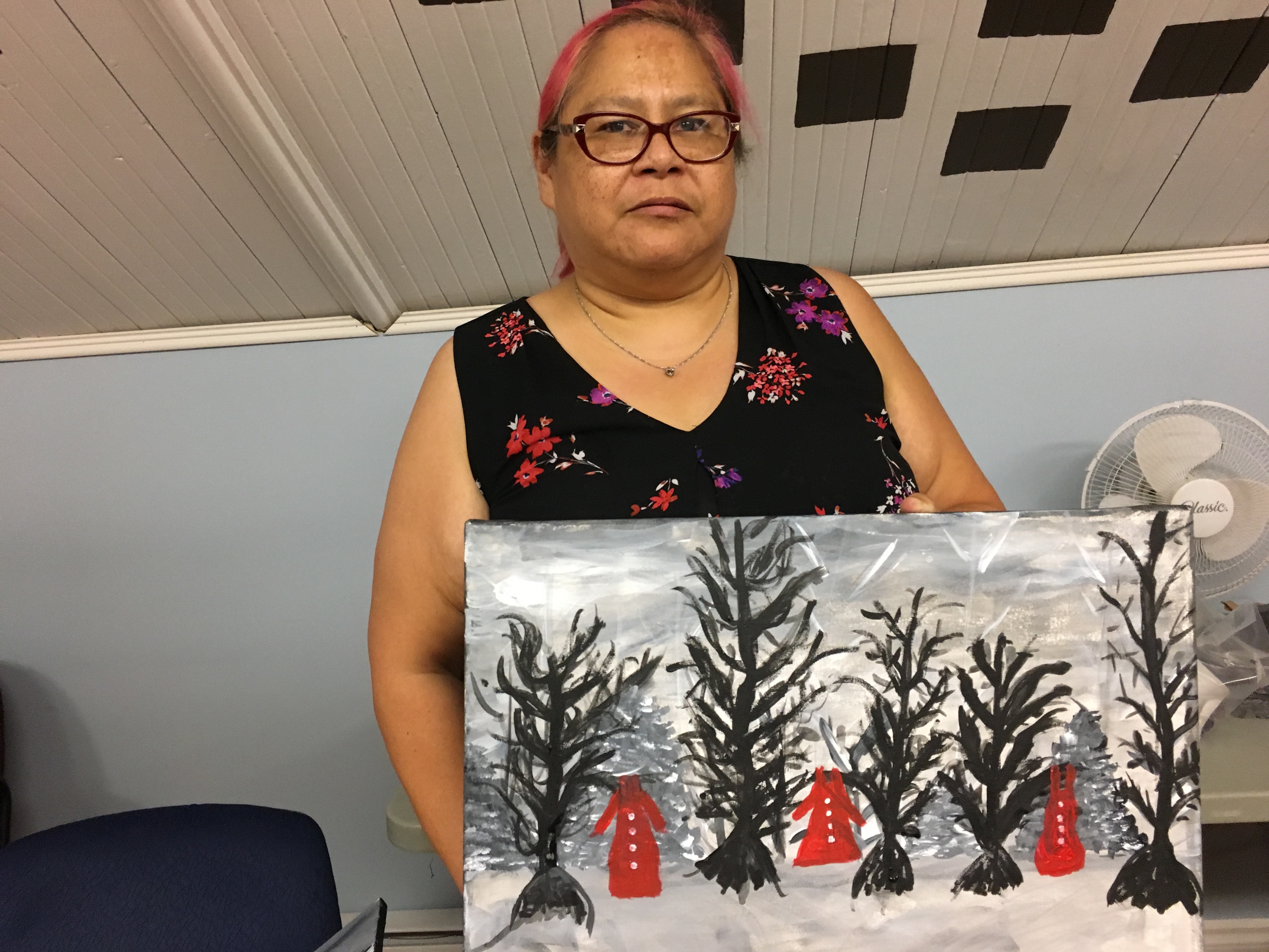 Patsy Gavin stands with her completed painting. (Natalia Goodwin/CBC)