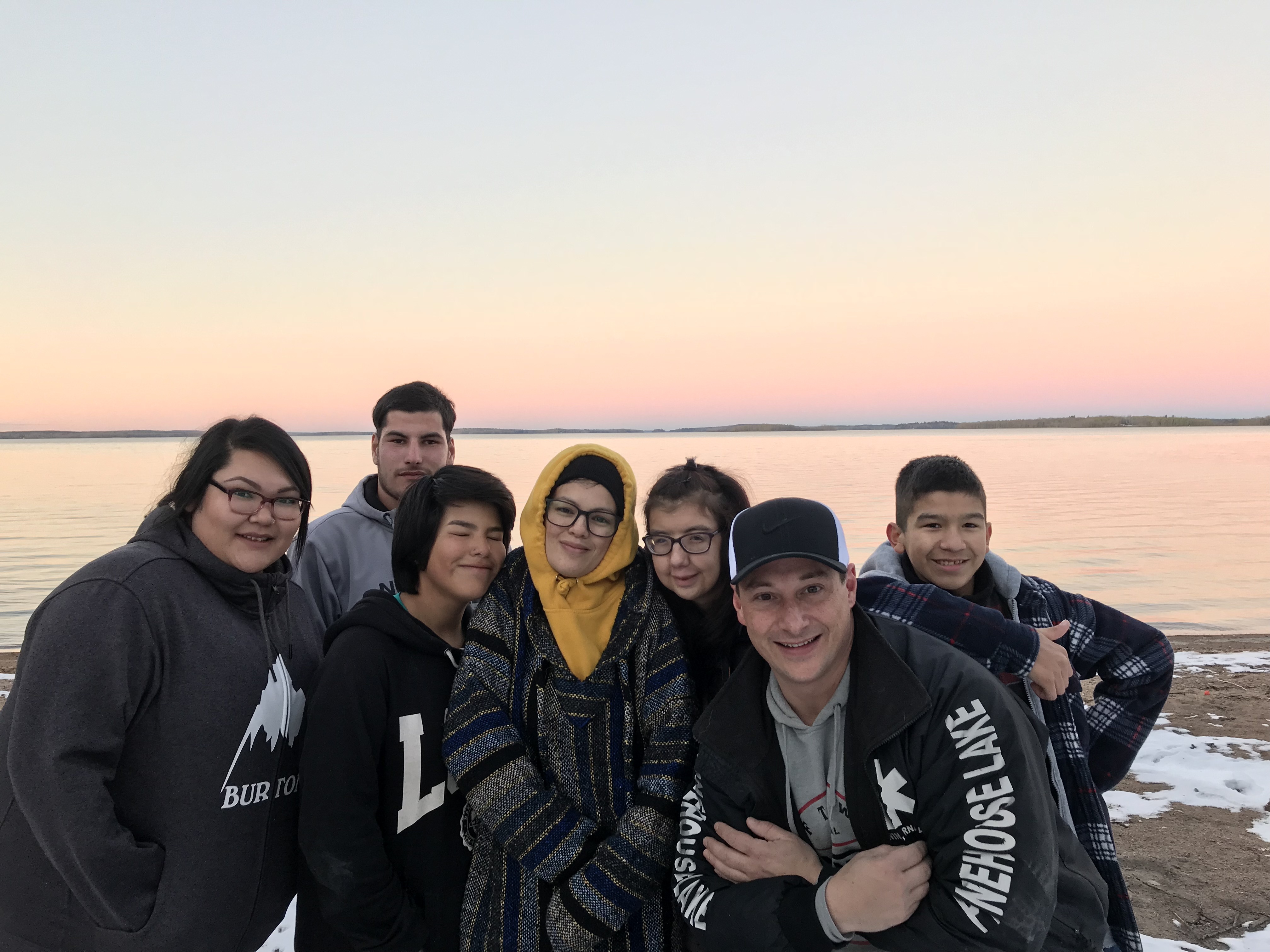 Erwin, second from right, poses with a few of the Pinehouse Photography Club's members. (Madeline Kotzer/CBC)