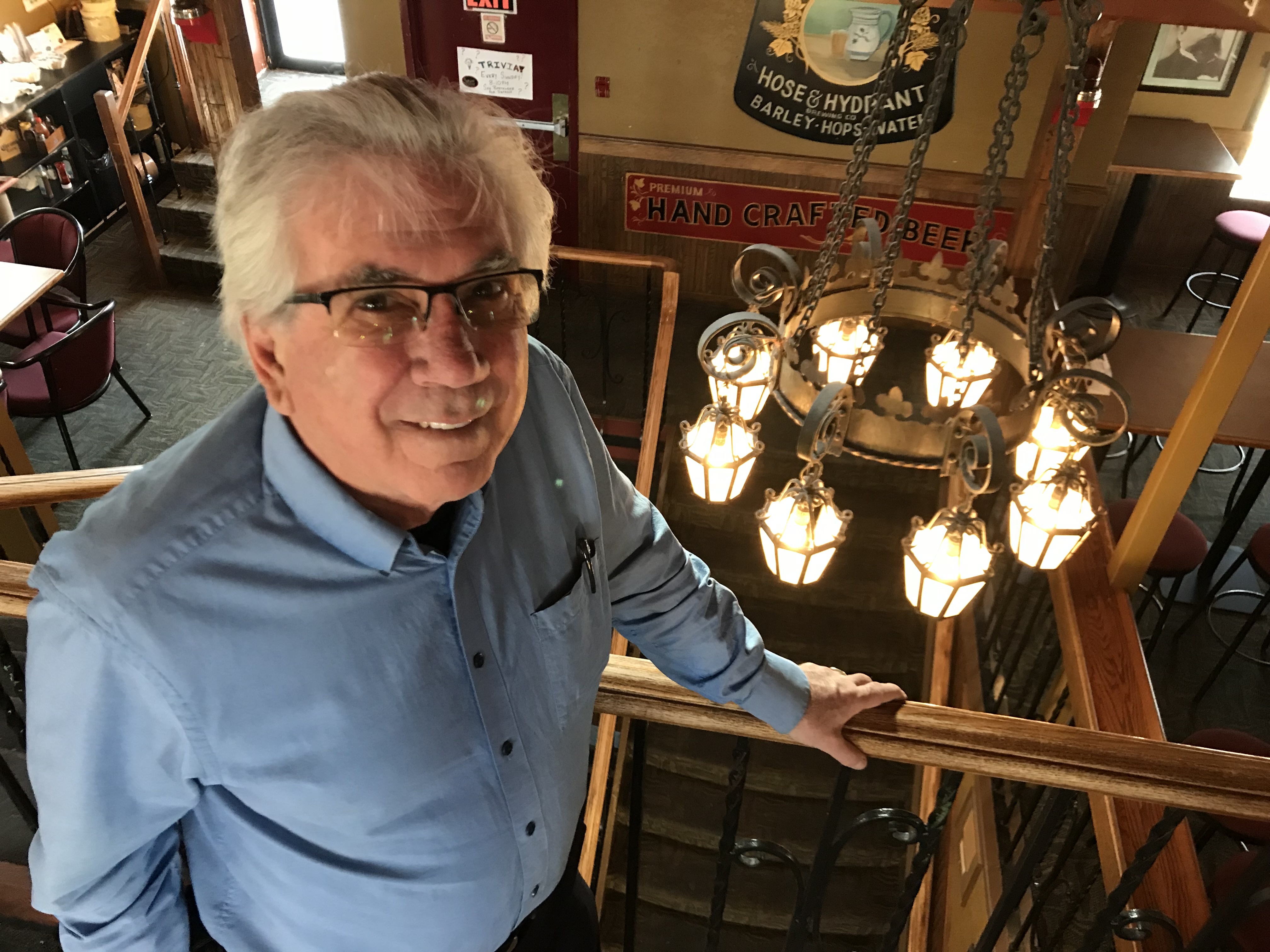 "They were just sitting in this warehouse, gathering dust, of no value to anyone else," says Ken Achs of Capitol chandeliers he incorporated into the Hose and Hydrant restaurant. (Guy Quenneville/CBC)