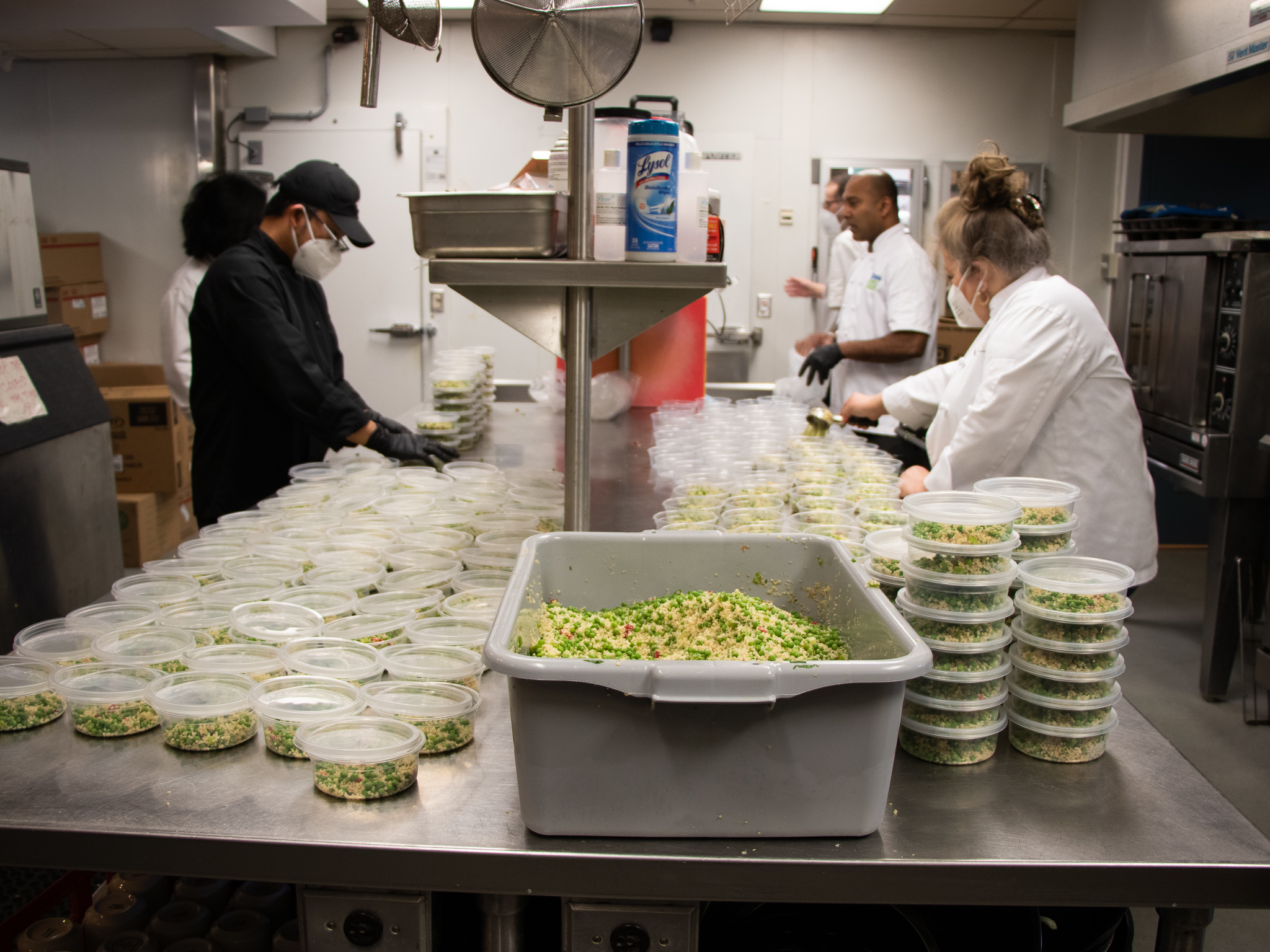 Tight quarters in the kitchen at the Langara Golf Course clubhouse mean staff find it hard to keep a safe distance from one another, but they hope that masks and frequent disinfecting helps. 